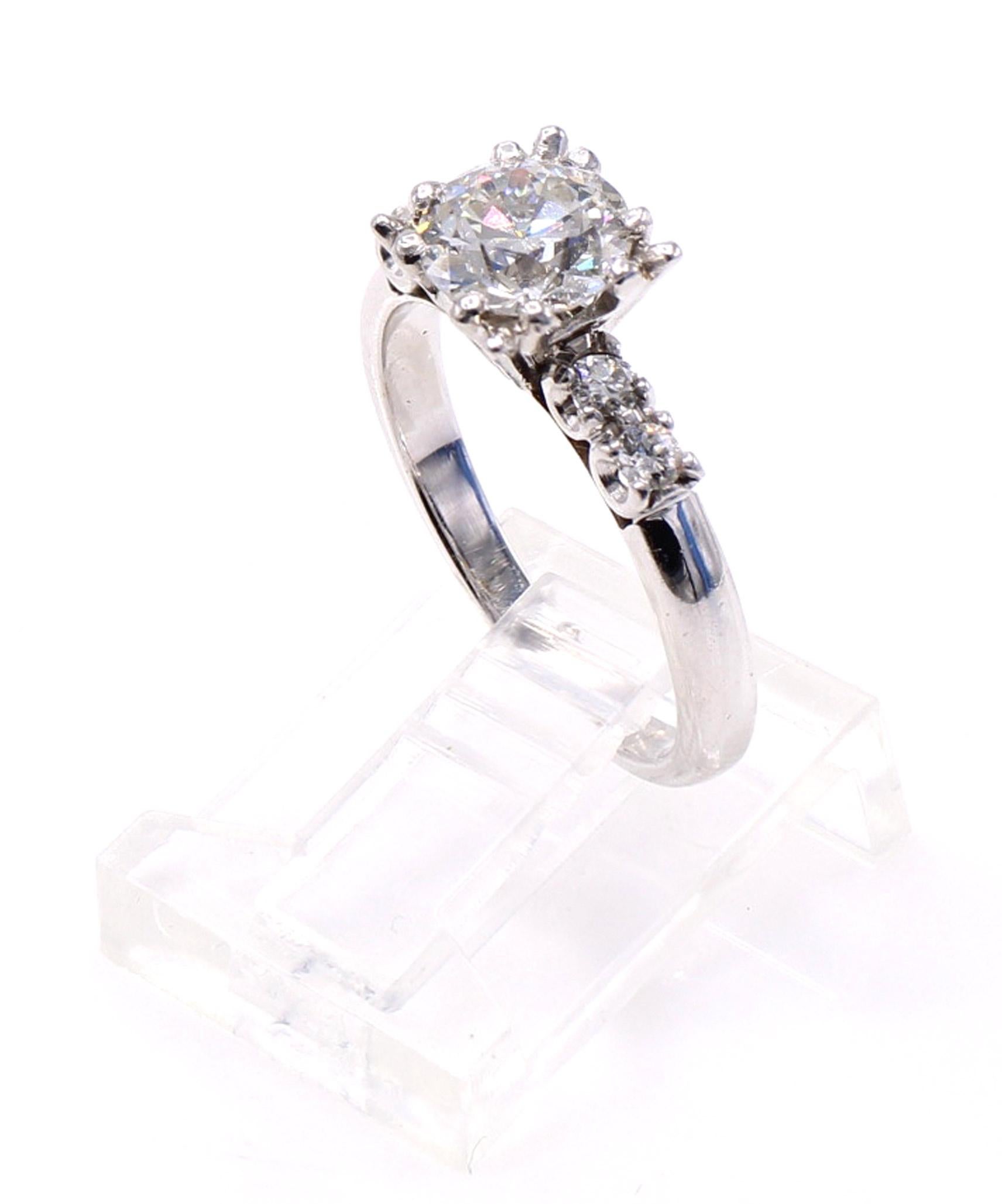 Beautiful handmade platinum and 14 karat white gold engagement ring centrally set with one Old European Cut diamond weighing 1.10 carats. This old-cut diamond has an amazing life, fire, and sparkle, and the fishtail prong setting gives this ring its