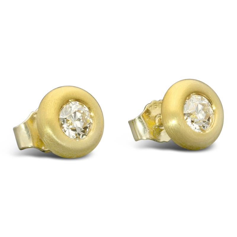 A beautiful pair of old cut diamond and yellow gold 'Doughnut' earrings by Hancocks, each earring set with an old European cut diamond weighing 0.80cts combined and of H/I colour and VS clarity, bezel set within a rounded doughnut-style setting in