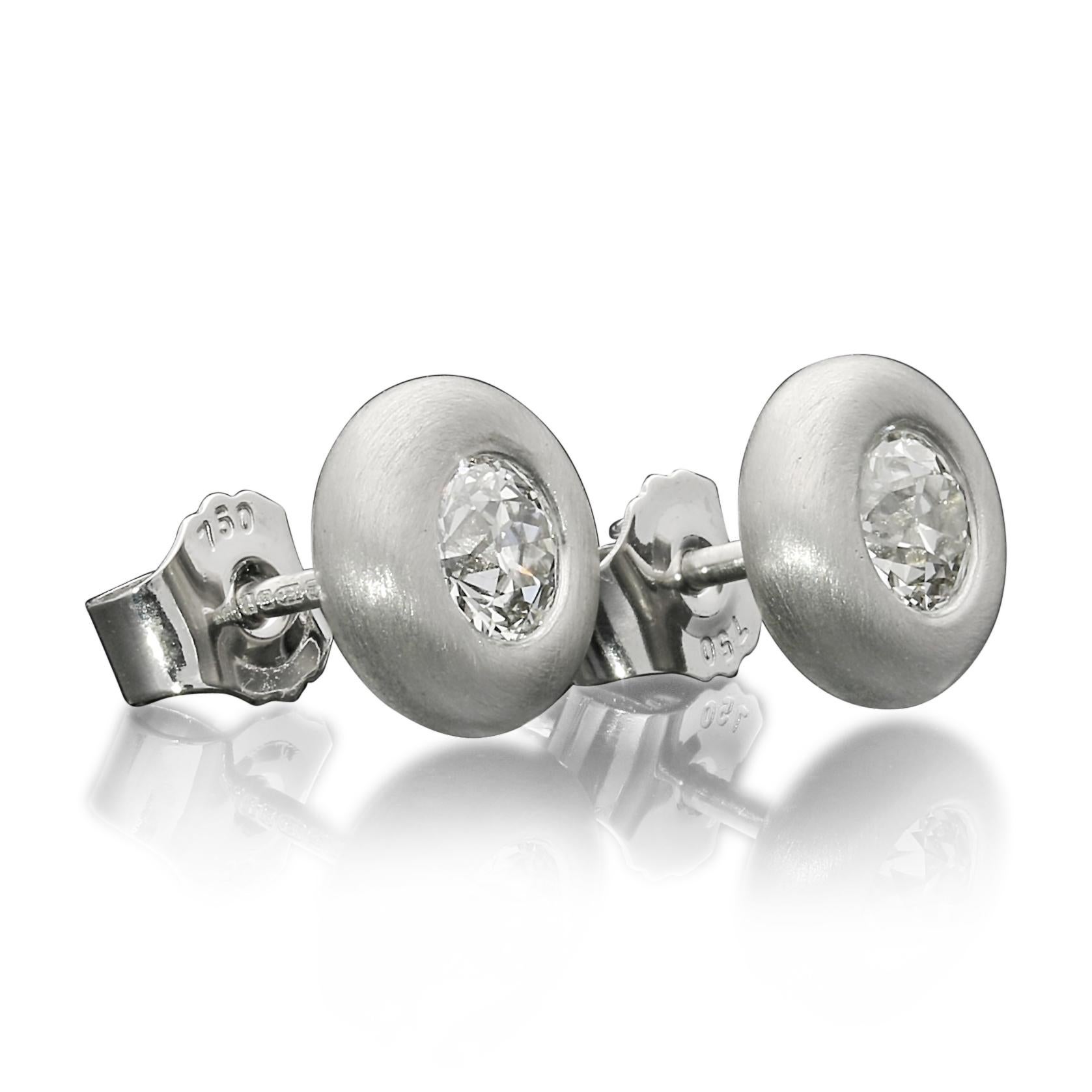 A beautiful pair of old cut diamond and yellow gold 'Doughnut' earrings by Hancocks, each earring set with an old European cut diamond weighing 0.80cts combined and of H/I colour and VS clarity, bezel set within a rounded doughnut-style setting in