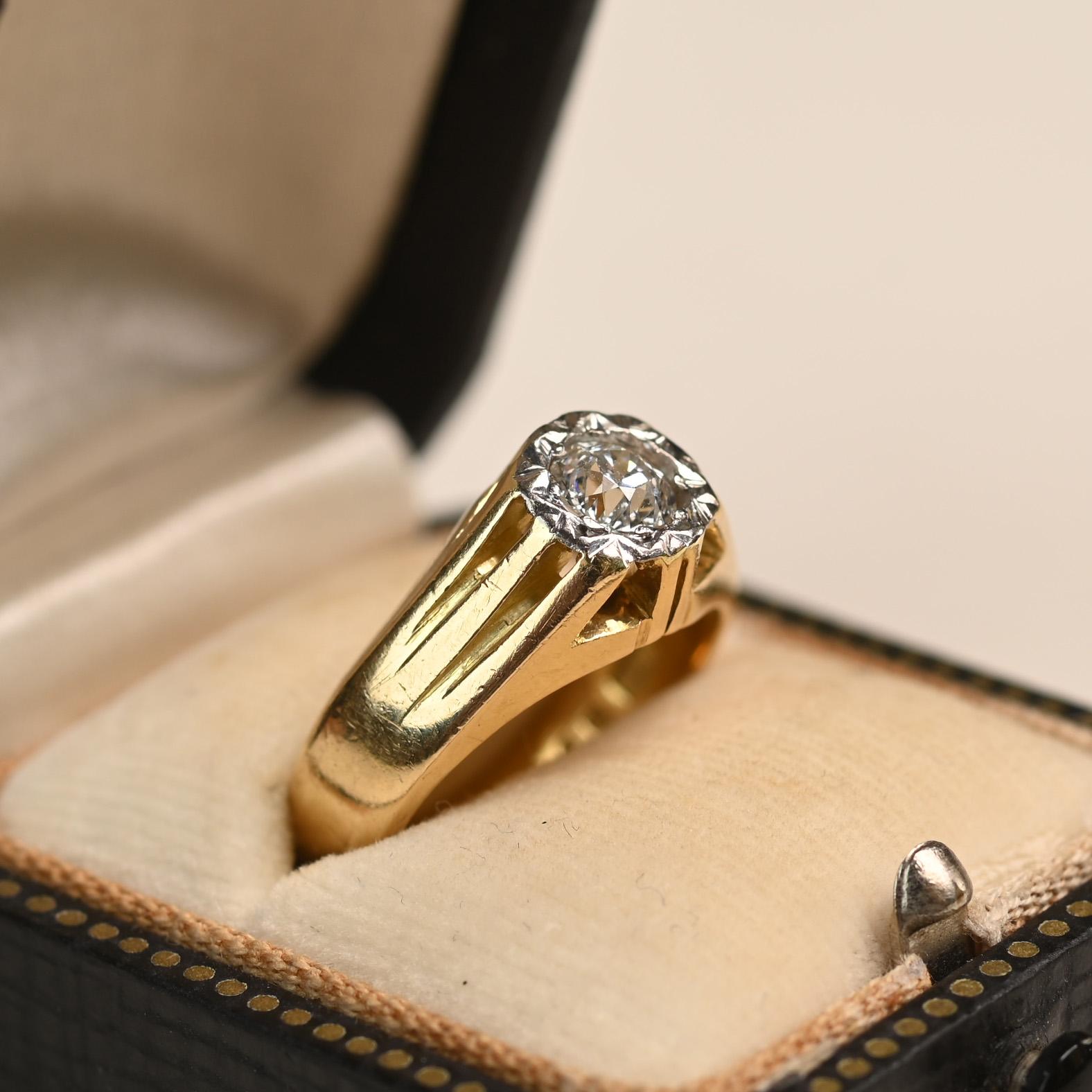 An English Edwardian ring, circa 1910, featuring an approximately 0.50-carat old European cut diamond with an I color and SI1 clarity. The center stone is framed by a textured platinum design that flows into an elegant triple-wire shoulder motif.