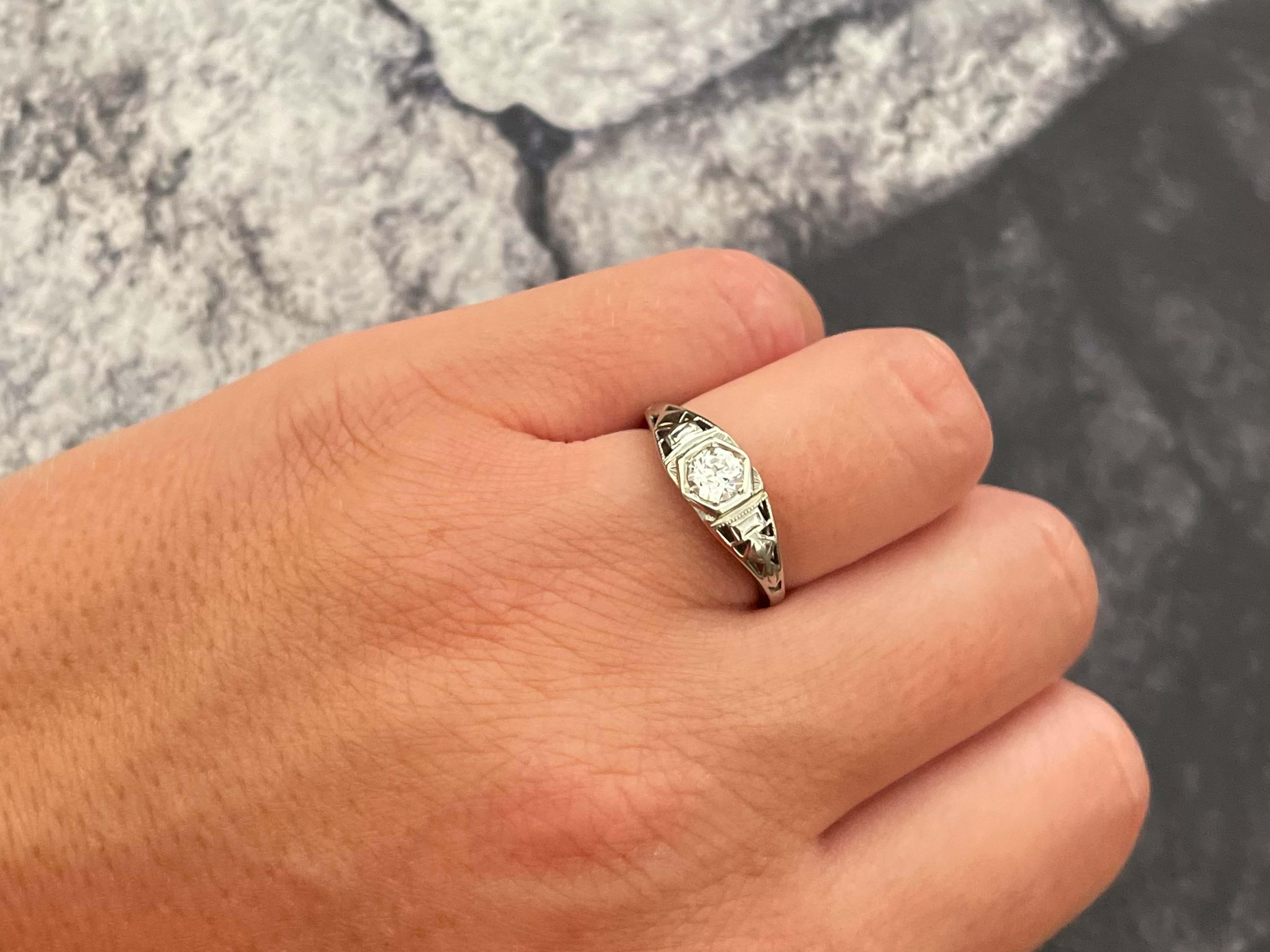 Item Specifications:

Metal: 18k White Gold

Style: Statement Ring

Ring Size: 6.25 (resizing available for a fee)

Total Weight: 2.1 Grams

Diamond Count: 1 old European cut 

Diamond Carat Weight: 0.33
​

Diamond Clarity: VS2
​

Diamond Color: