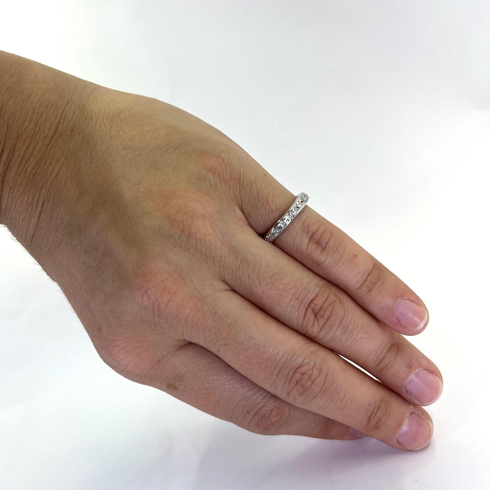 Vintage Platinum Eternity Band Featuring 23 Old European Cut and Single Cut Diamonds of VS/SI Clarity and G/H Color Totaling Approximately 0.55 Carats. Finger Size 4.75. Finished Weight is 4.2 Grams.