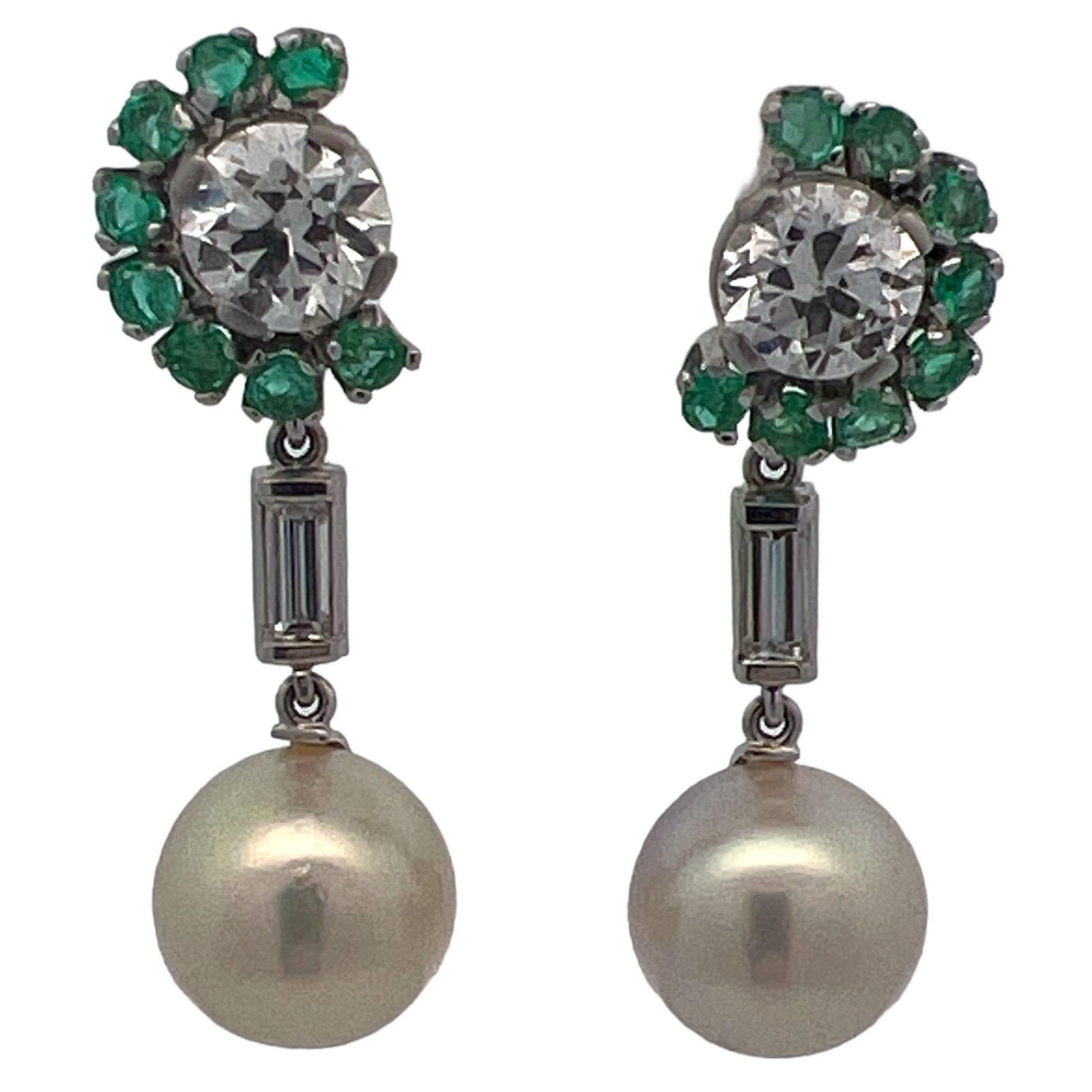 Gorgeous diamond and South Sea Pearl drop earrings fashioned in platinum. The earrings features 2 Old European cut diamonds weighing 2.09 CTW. The diamonds are GIA certified E and G color and SI1/SI2 clarity. The diamonds are surrounded by emerald