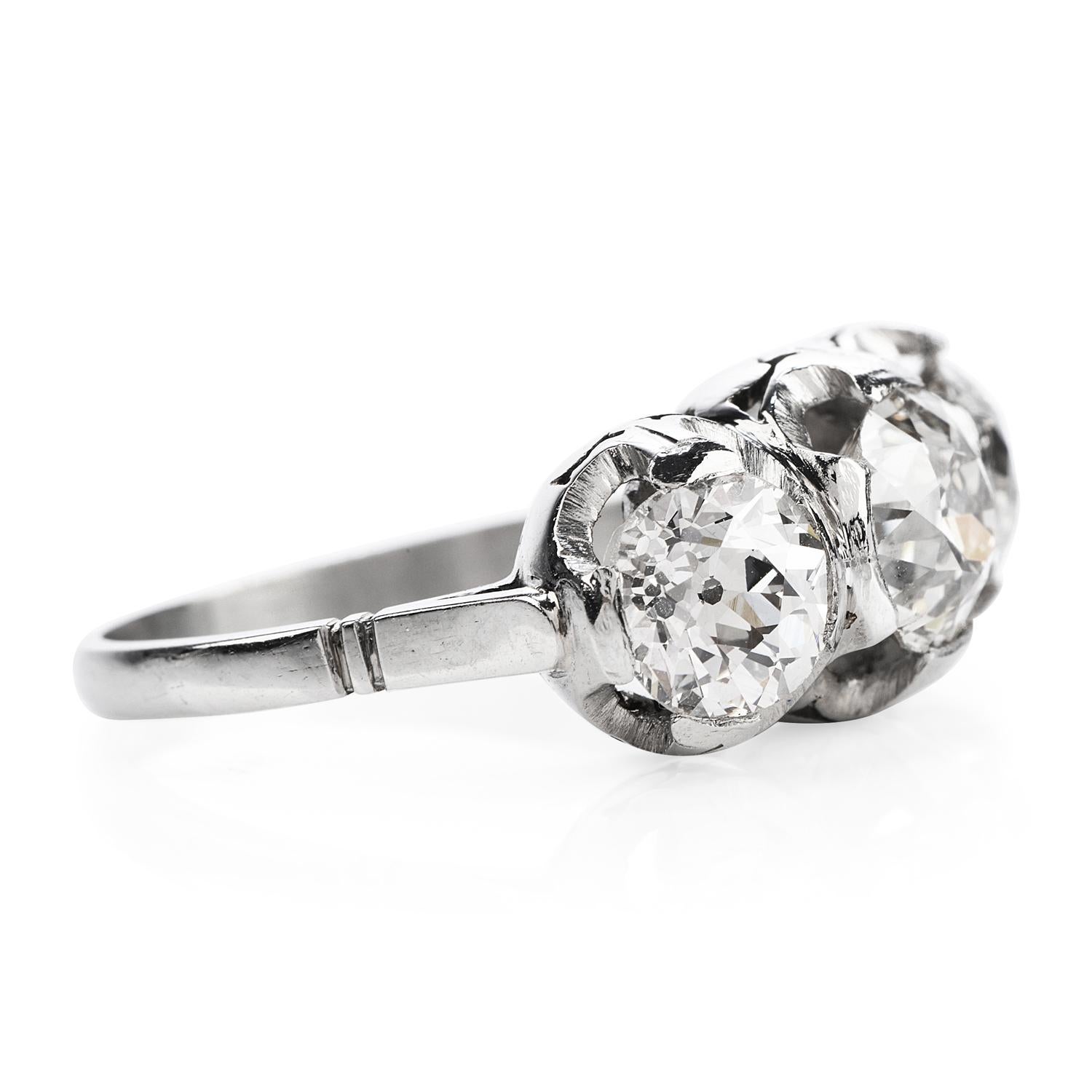 Vintage, sparkly & full of life, this three-stone diamond engagement ring is perfect for creating memories.

Crafted in solid Platinum, the center is adorned by a (3) Old European cut, Half bezel-set, high-quality genuine diamonds weighing in total