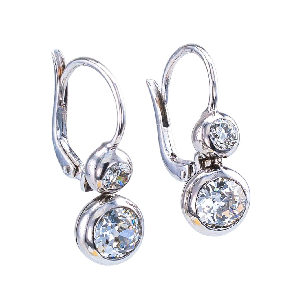 Old European cut diamond silver and gold drop earrings circa 1930.

DETAILS:

DIAMONDS: two larger old European-cut diamonds totaling approximately 1.50 carats, two smaller old European-cut diamonds together weighing approximately 0.30 carats, the