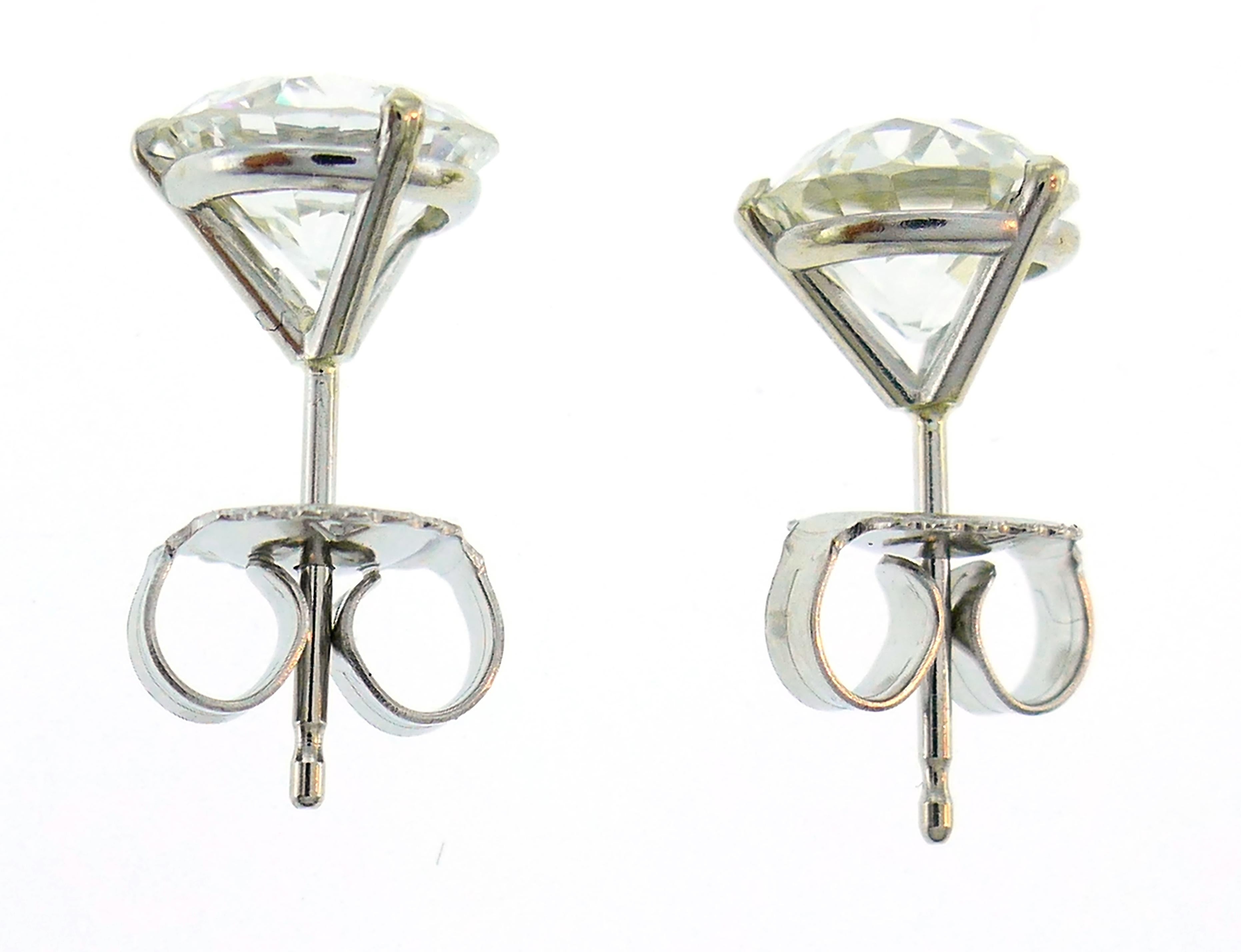 A pair of classic diamond stud earrings that features two 1.39-carat each Old European cut diamonds, H-I color and VS2 clarity. The settings are made of 14 karat white gold. 
The earrings measure 5/16 x 5/8 inch (1.5 x 0.8 cm) and weigh 1.6 grams.