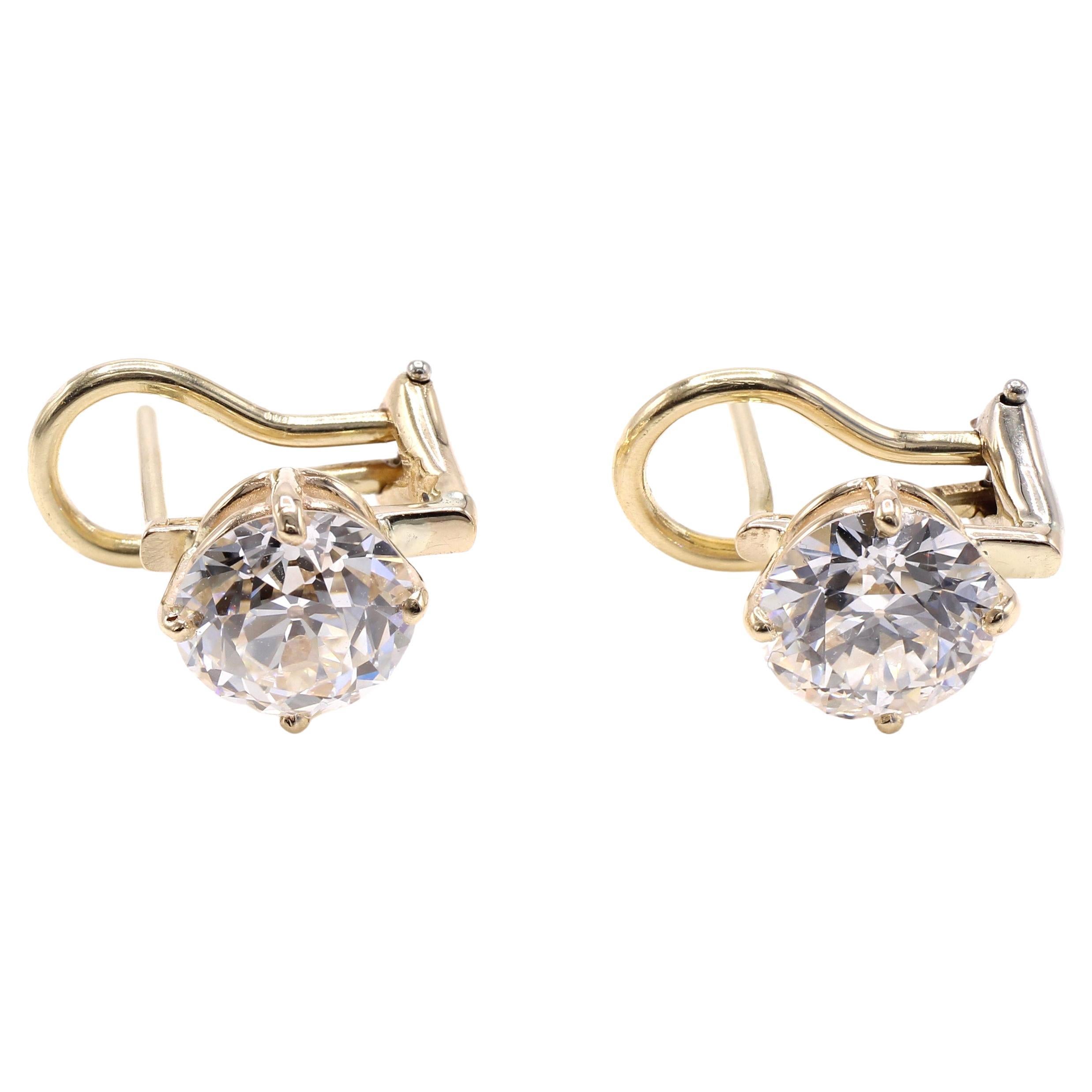 A pair of well matched beautifully cut Old European Cut diamonds are set in yellow gold mount secured by a post and omega clip back. The diamonds are certified by the GIA - one weighing 1.50 carats with a color grade of H and clarity of VVS 2, the