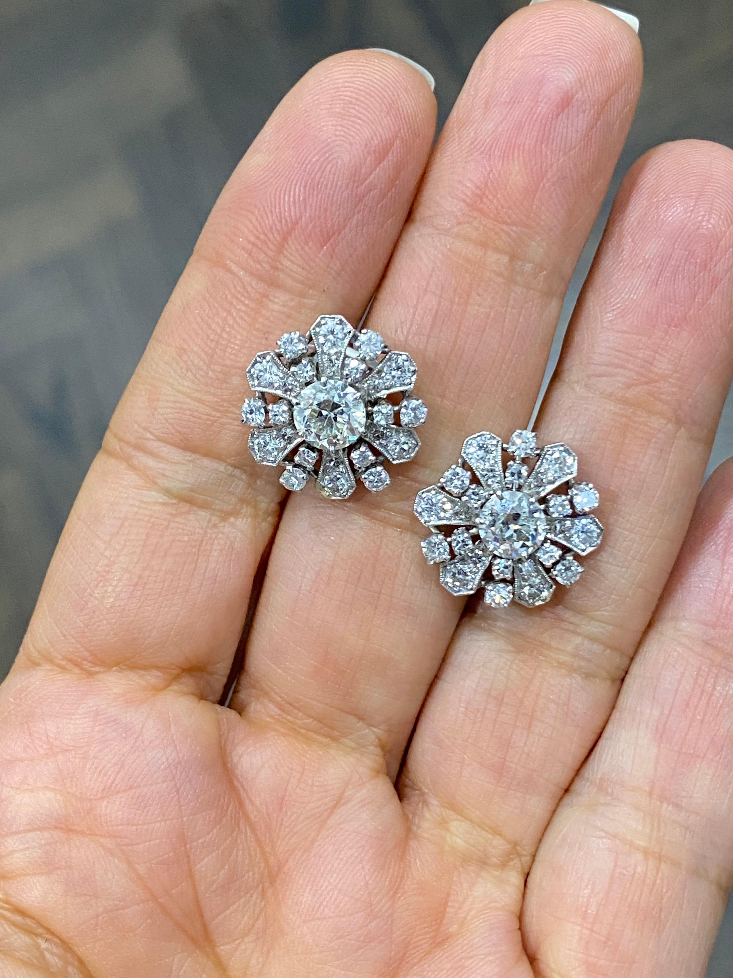 Divine Platinum large cluster vintage studs. 2 Center old European diamonds= approx. 1.75 Carats. ( H, SI2) With additional 24 round brilliant and 24 single cut rounds surrounding= approx. 1.25 carats. (G-H, VS-SI)
Approx. 3 carat total. 
5/8 inch