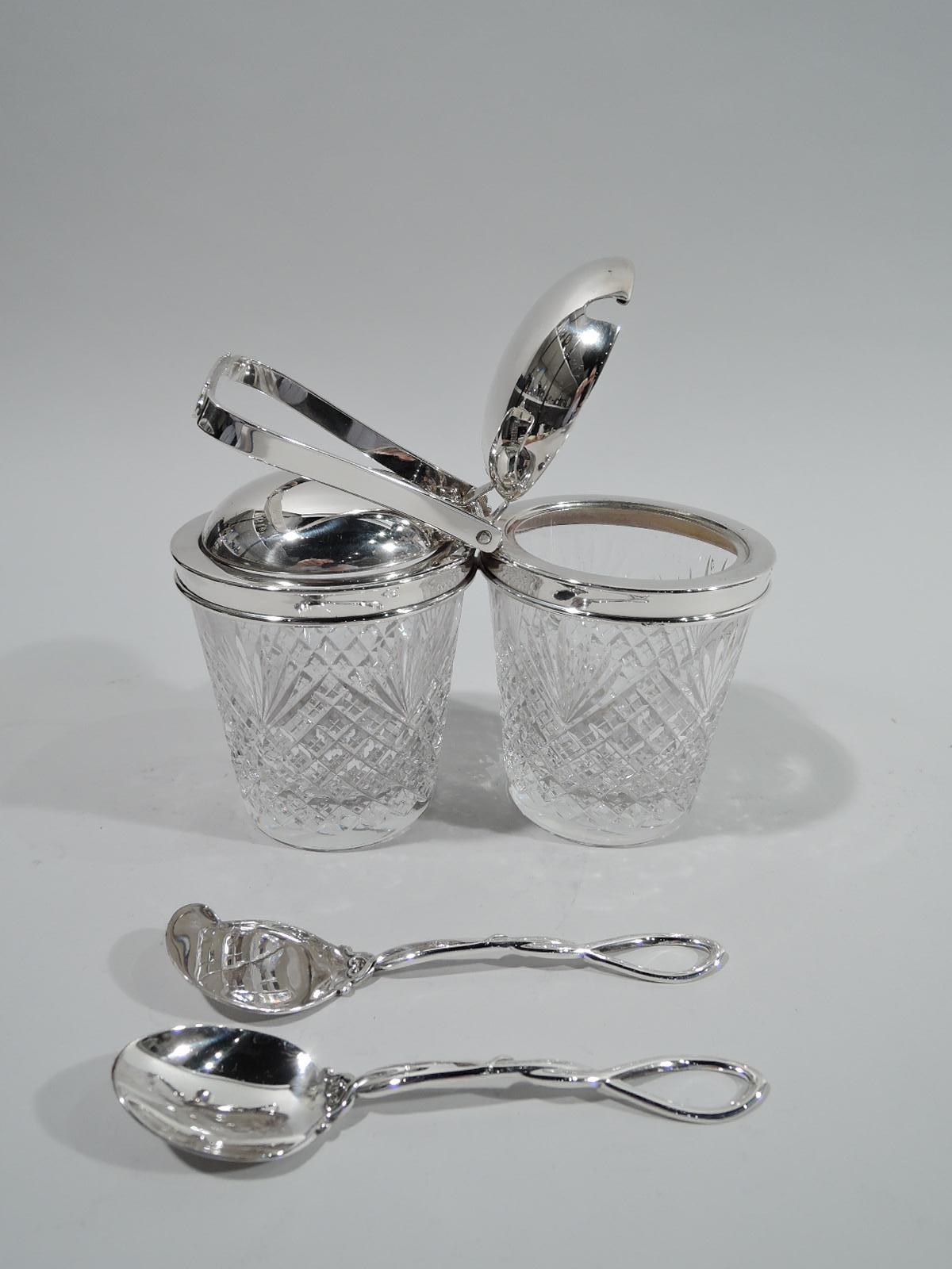 Old-fashioned sterling silver and glass double jam jar. Made by Hawkes in Corning, New York, ca 1950. Two jars, each with straight and tapering sides and raised diaper and fern pattern. Sterling silver collars joined by mount with open and tapering