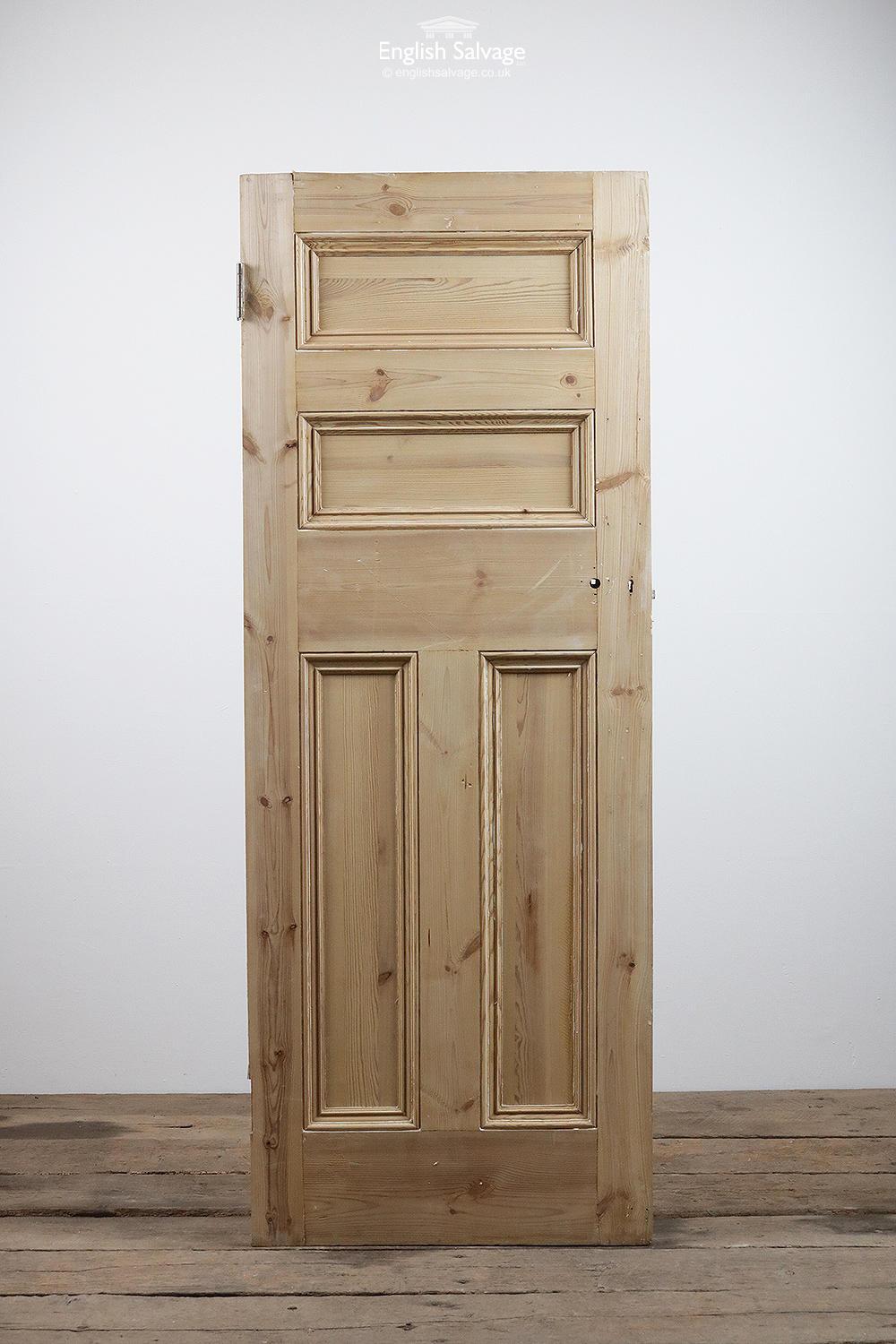Reclaimed stripped pine door with four beaded panels. Lock, handle and nail holes present.