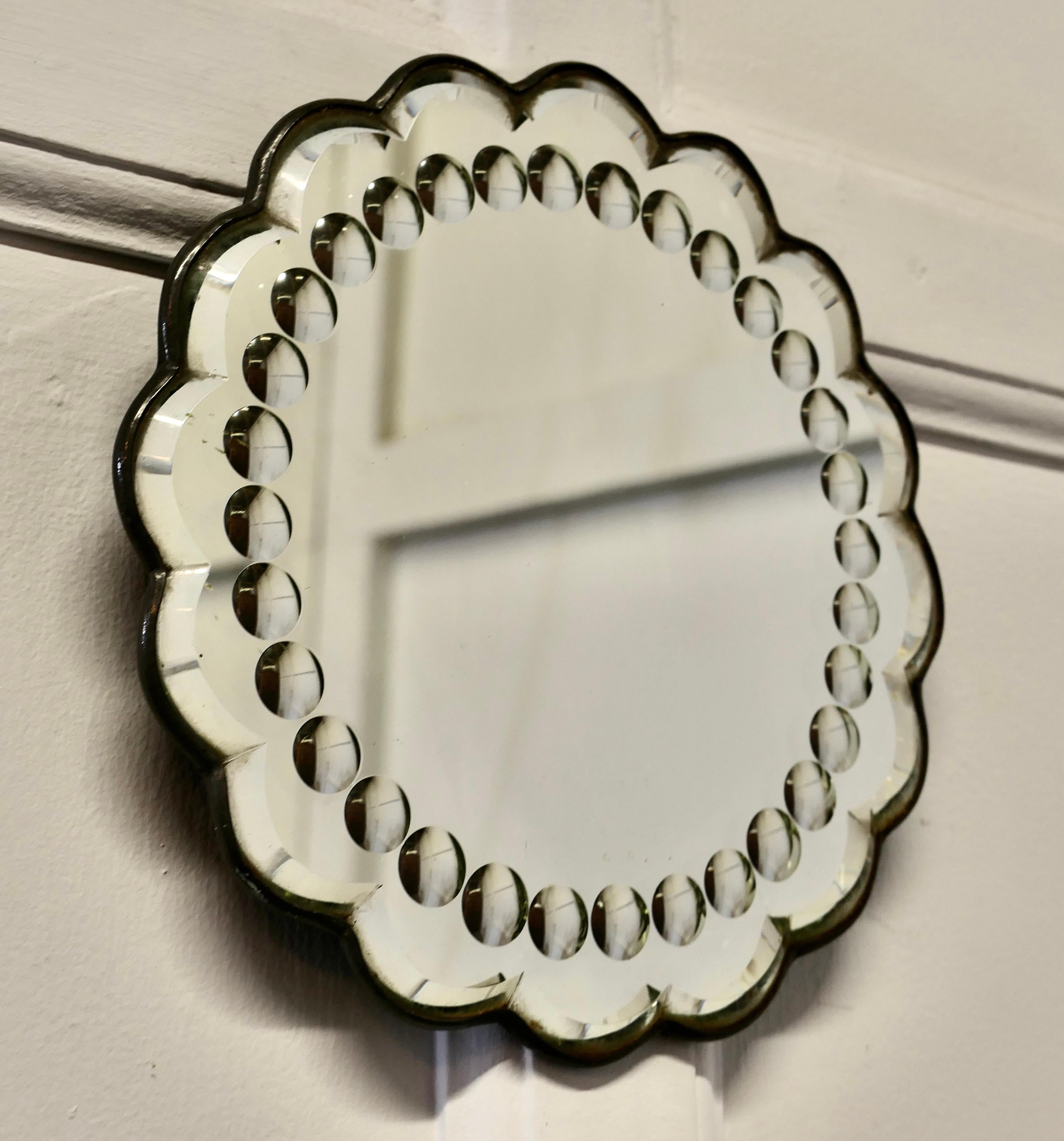 Old foxed Art Deco shabby circular mirror .

A lovely piece for the right person, the mirror is round with bevelled scalloped edging.
This unusual mirror has bevelled roundels etched into the thick glass, the mirror is slightly foxed around the