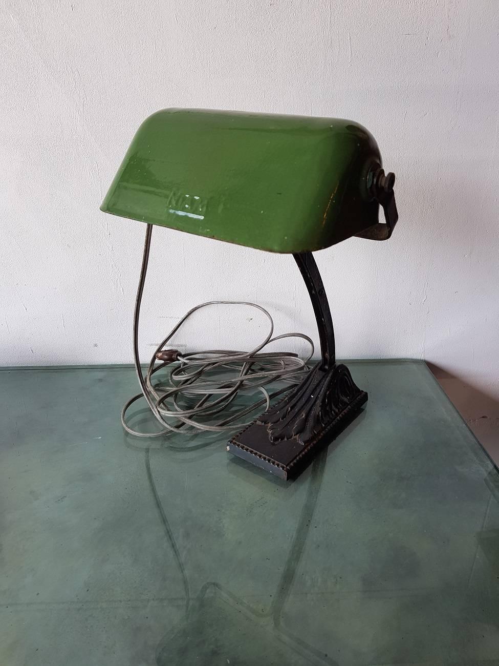Old French cast iron and adjustable Notary/Bankers desk lamp with enamel cap and marked Niam, first half of the 20th century.

The measurements are,
Depth 20 cm/ 7.8 inch.
Width 24 cm/ 9.4 inch.
Height 41 cm/ 16.1 inch.
 
