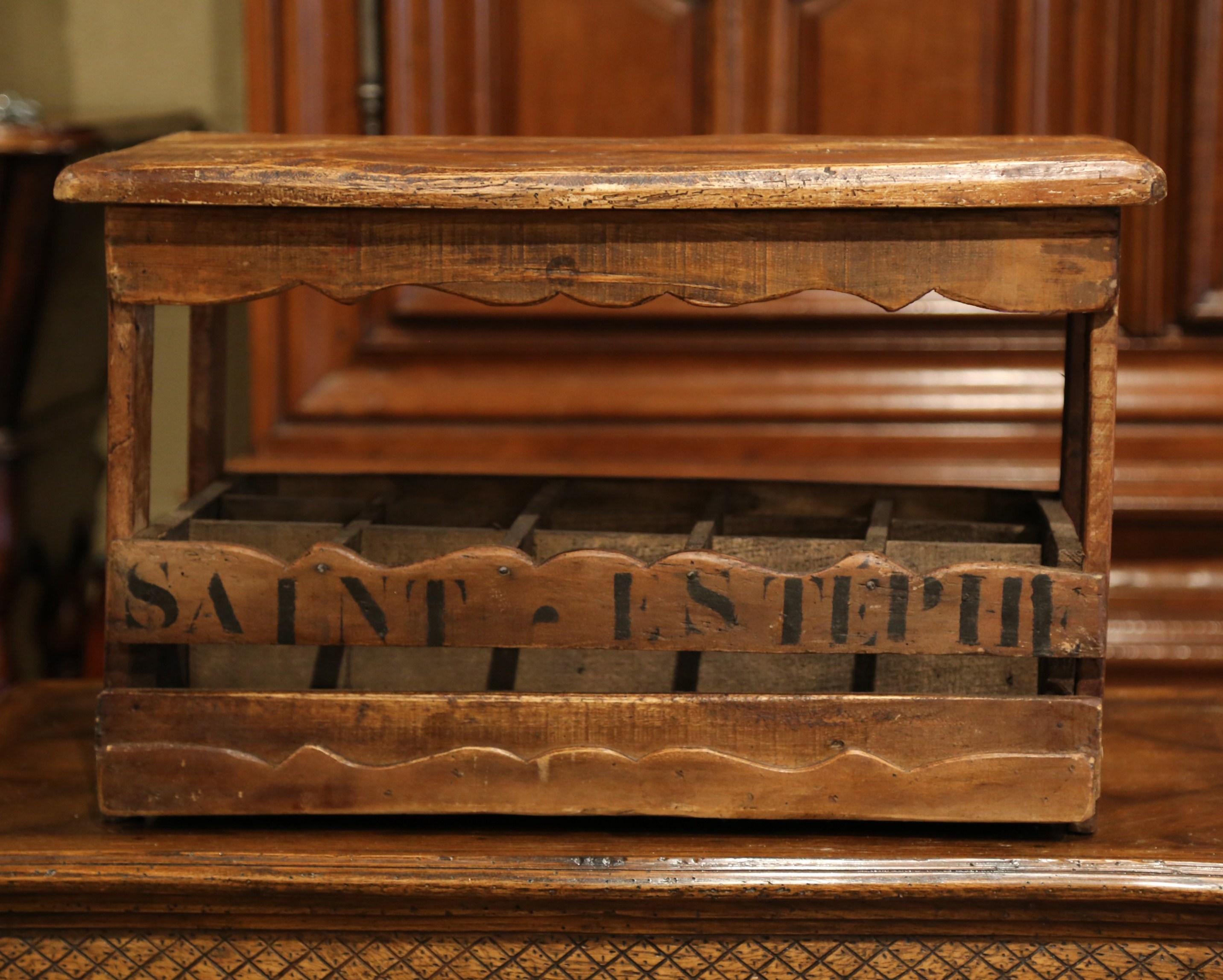 This interesting wooden wine or champagne bottle holder was crafted in France, circa 1920. The useful antique cabinet, made with old pine timber, has fifteen inside slots for wine or champagne bottles and has a hinged top for convenience. The piece