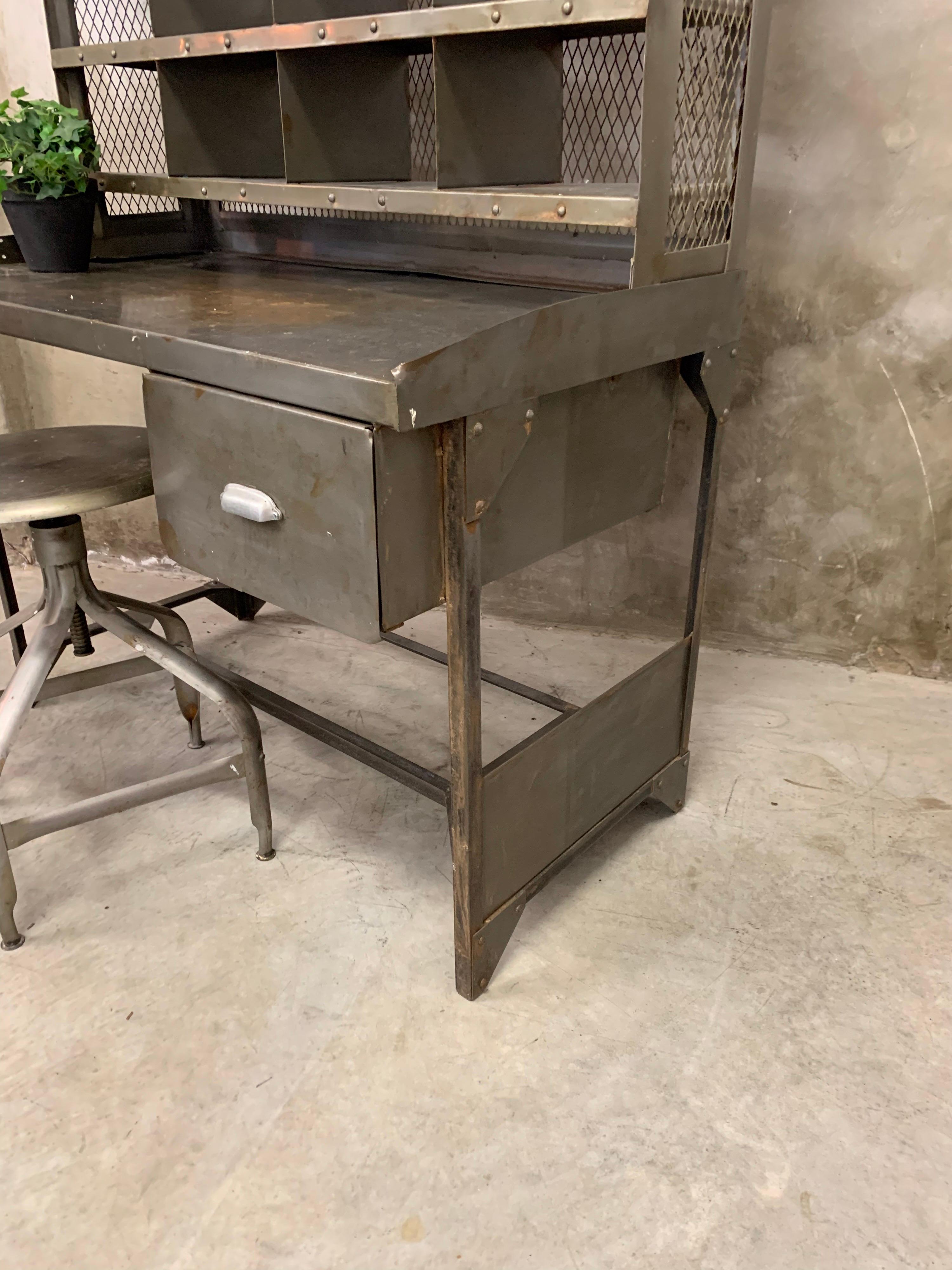 Old French postal sorting cabinet. All metal including adjustable original metal seat. Dating from the 1950s and are rare to find. The cabinet itself consists of 2 parts. Stands separately, but can also be screwed in if necessary (screws not