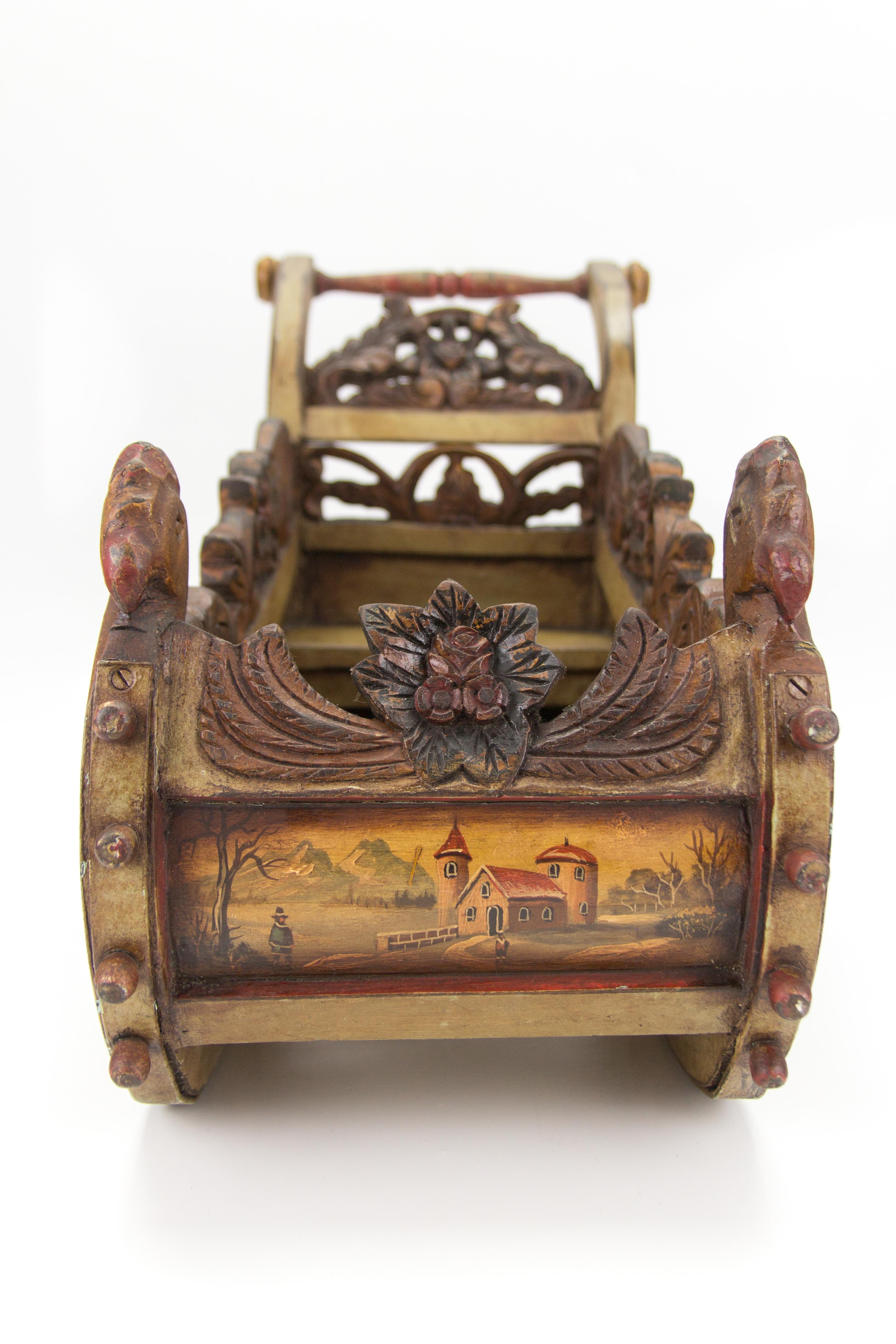 This gorgeous genuinely handcrafted thick wooden sleigh features floral motif carving and imposing carved turkey heads on each side of the sleigh front. All sides are exquisitely hand painted and depict antique winter scenes - people near castles