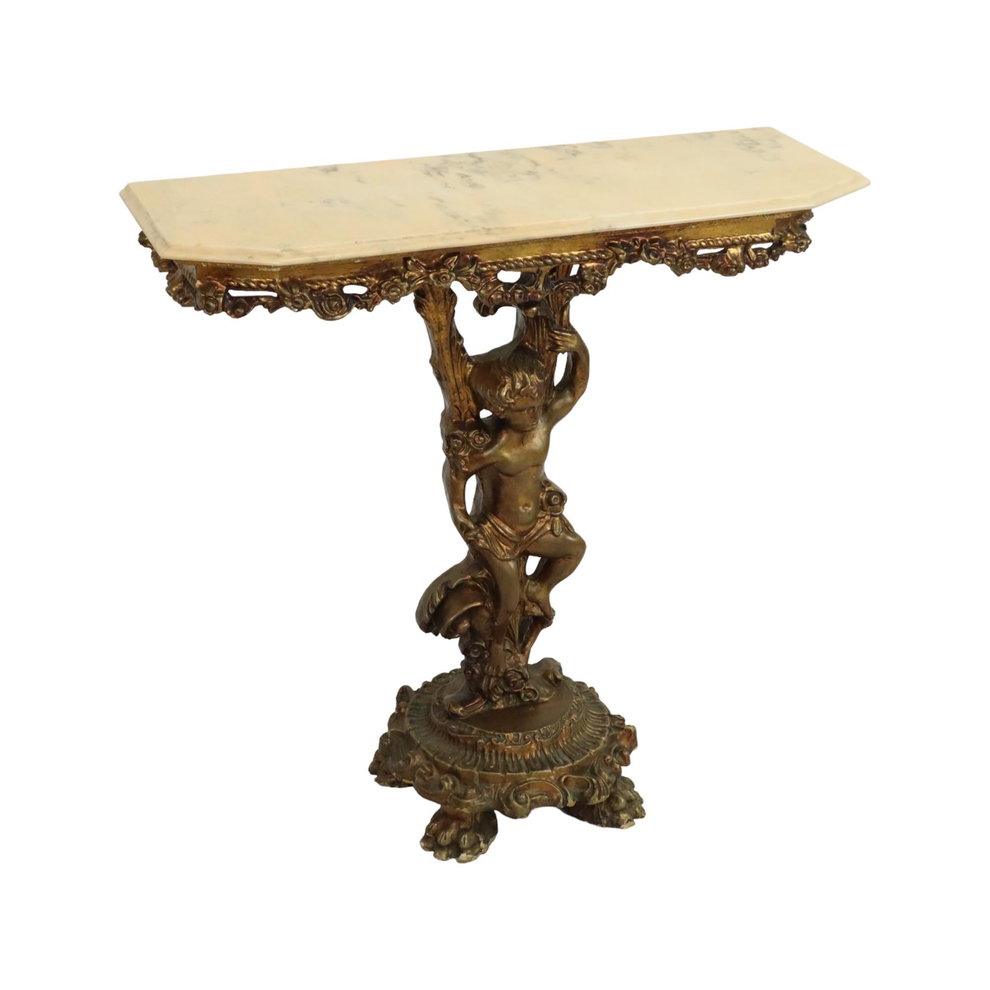 Beautiful gilded console made of wood and resin, richly decorated with a cherub or angel, acanthus, flowers, large claw feet and a beautifully veined marble top, circa mid-20th century.

This impressive console in Hollywood Regency style looks great