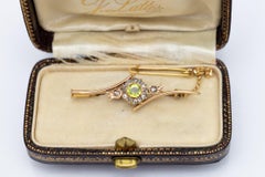 Old gold brooch with olivine and diamonds, Russia, early XX century.