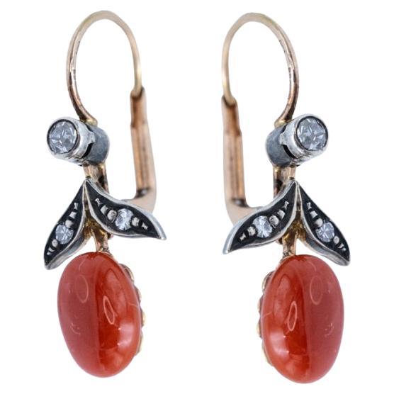 Old gold earrings with coral and diamonds.