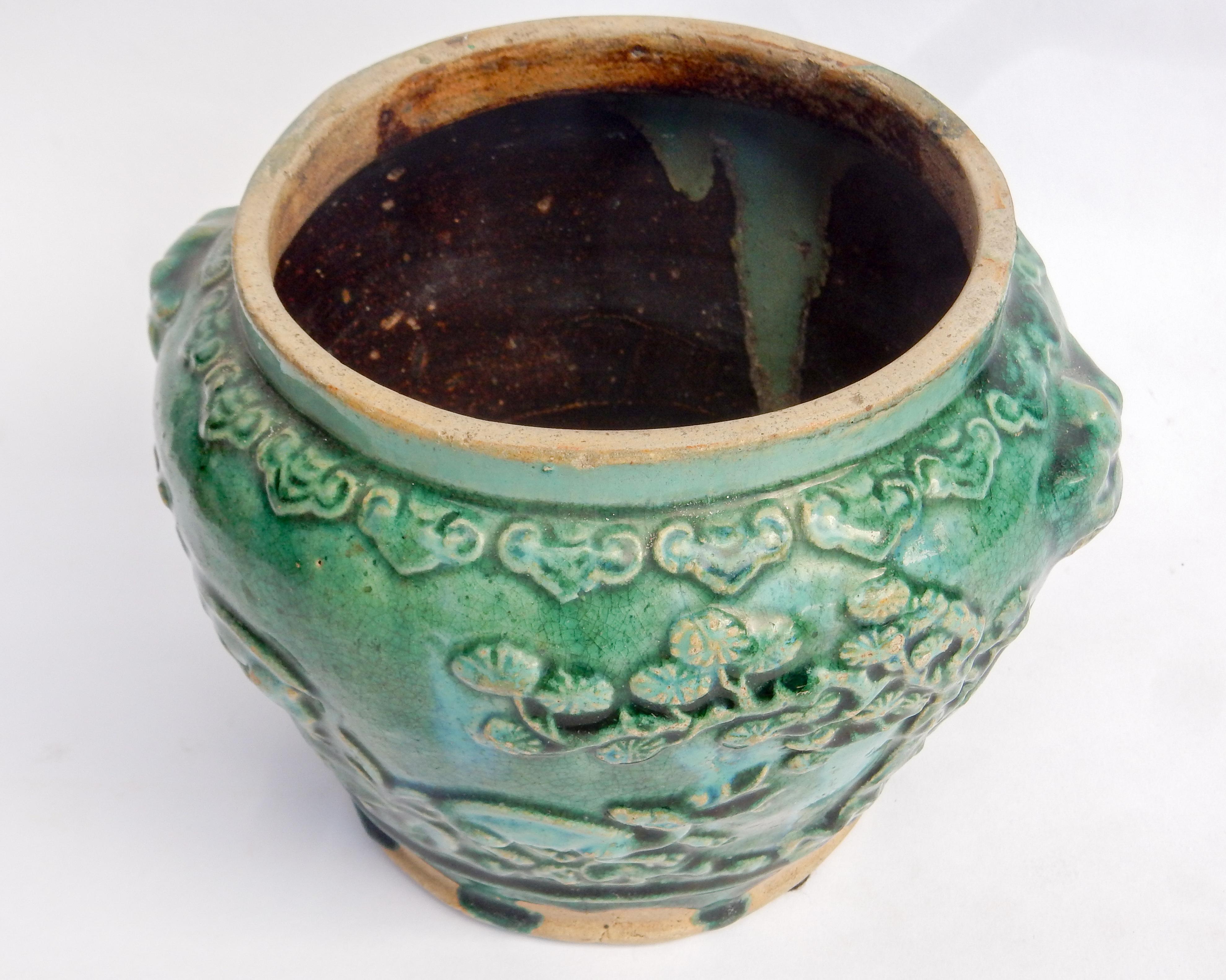 Green glazed pot from Southern Thailand found in Java, late 19th century
This small pot has a lovely green glaze and is decorated all around with auspicious three dimensional motifs cherry blossoms, dragons, a deer, an elephant and lion heads. The