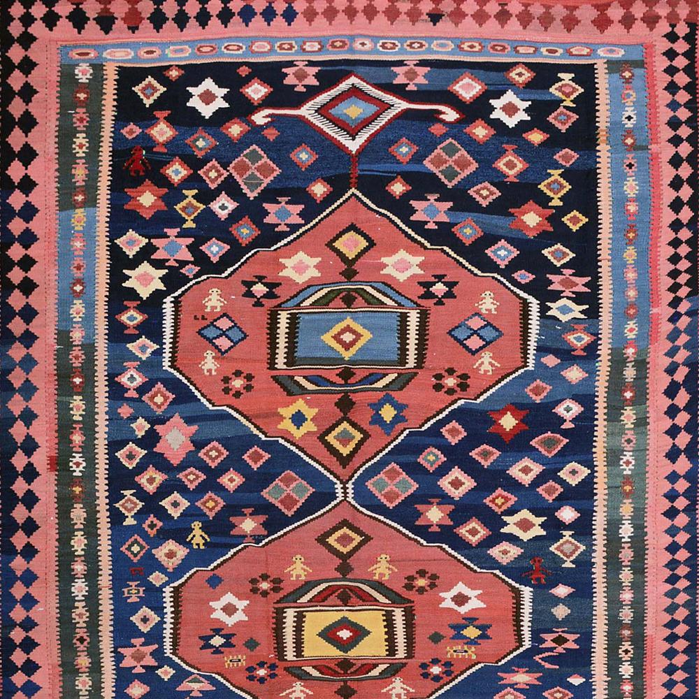 Mid-20th Century Handwoven Caucasian Kilim Carpet

This handwoven Kilim comes from the Caucasus and is made of durable, but soft, textured wool. The ornaments in the middle are surrounded by strong symbols in red shades, which resemble a tribal