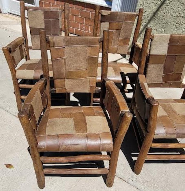 This set of Old Hickory Arm chairs are in fine, and in sturdy condition.These chairs were made by the Old Hickory Furniture Company from Martinsville, Indiana. They have been upholstered in a vintage leather patchwork rug. It is very similar to a