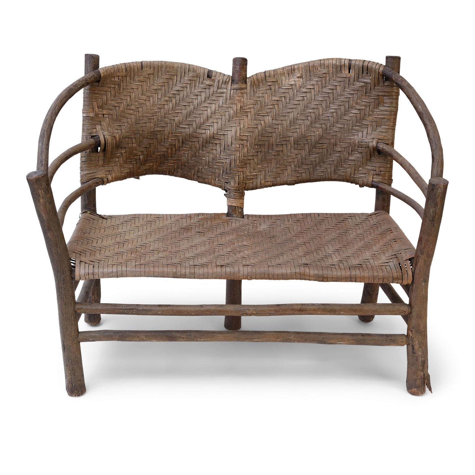 Old Hickory barrel-back settee with a bent hickory frame and a woven splint seat and back.

Note: Regional differences in humidity and climate during shipping may cause antique and vintage wood to shrink and/or split along its grain, veneer to