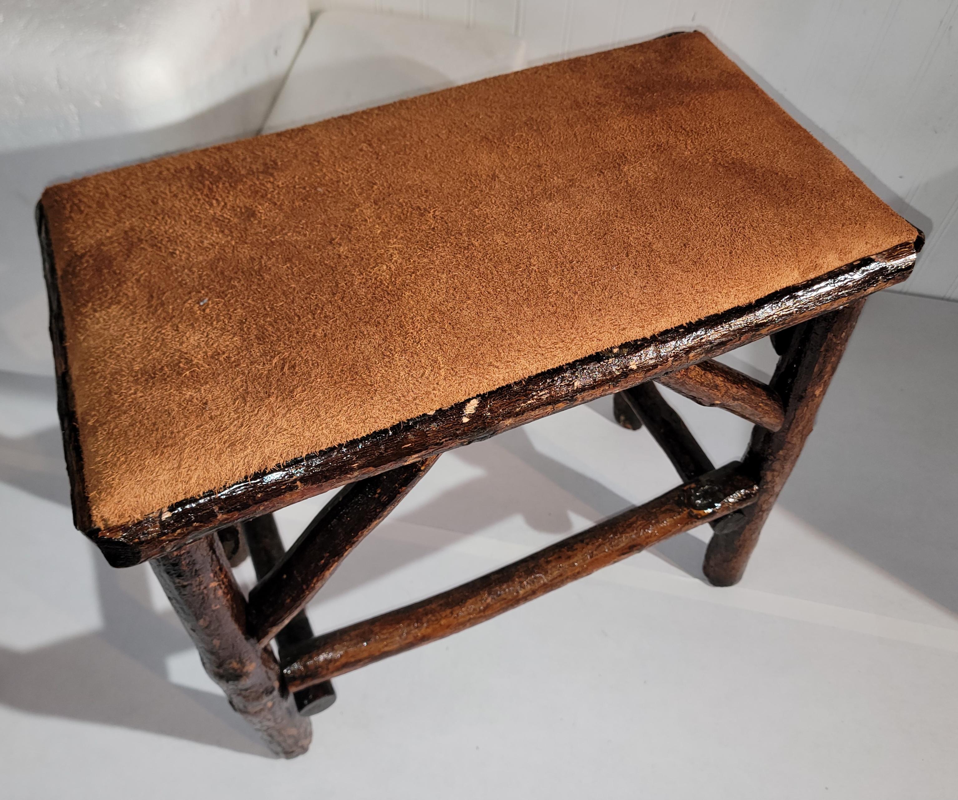Early Old Hickory bench with suede seat newly upholstery and in strong ,sturdy condition.