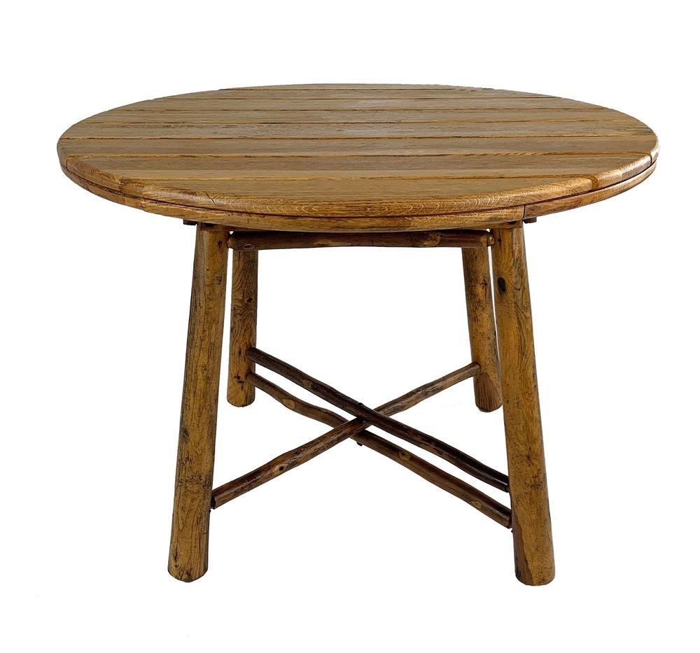 The round breakfast / dining table has an oak slat top and a hickory pole base with interesting triple pole X stretchers. Branded Old Hickory Furniture Company, Martinsville, Indiana.

Circa 1940s
Table: 40” diameter, 30” height.
