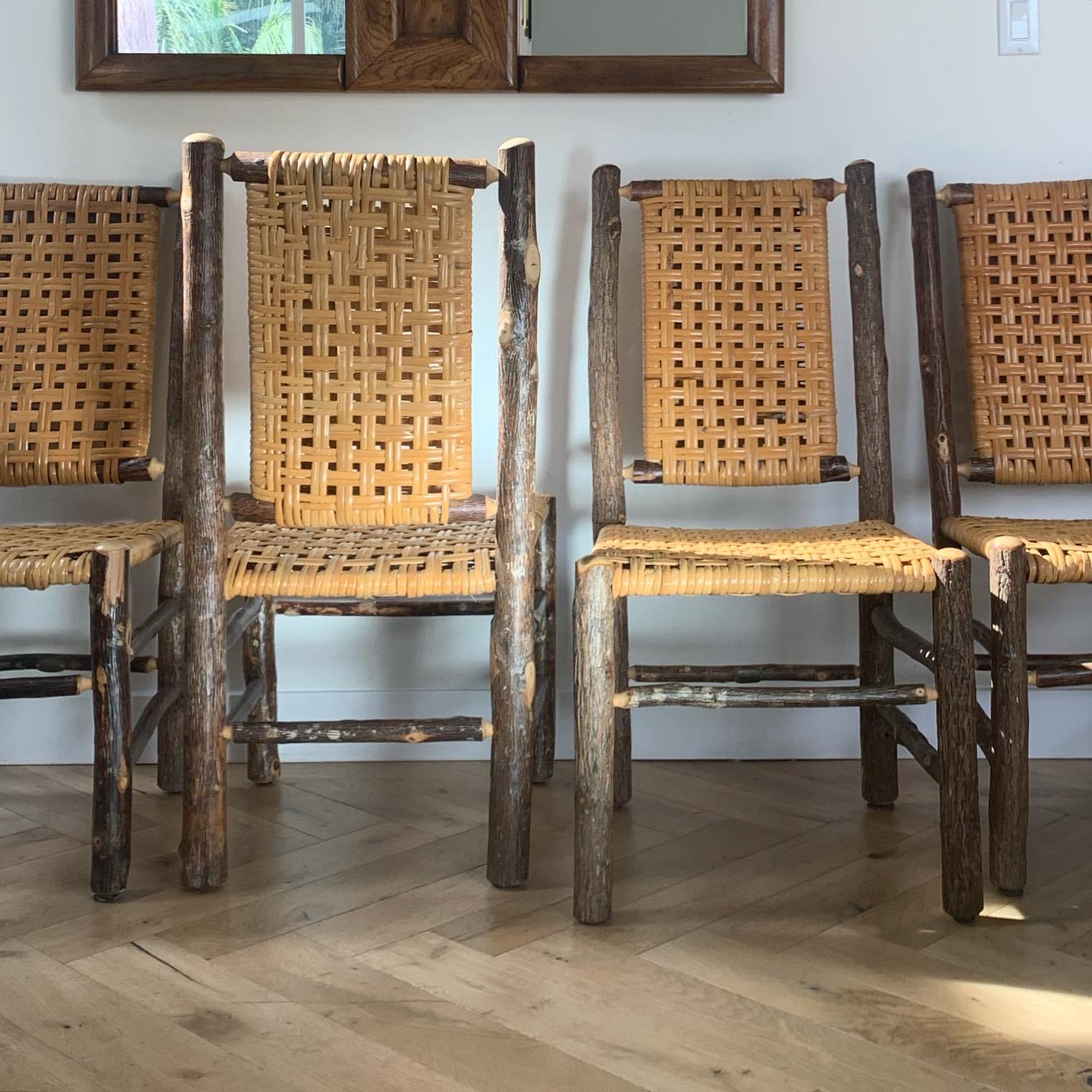 Set of 4 rustic prewar Old Hickory chairs, signed, with caning, circa 1940s. Great condition with minor signs of age, which includes a bit of unraveling. 

Measures: 19.25” W x 20.25” D x 39” H 
Seat: 18.75” W x 19.25” D x 18” H.