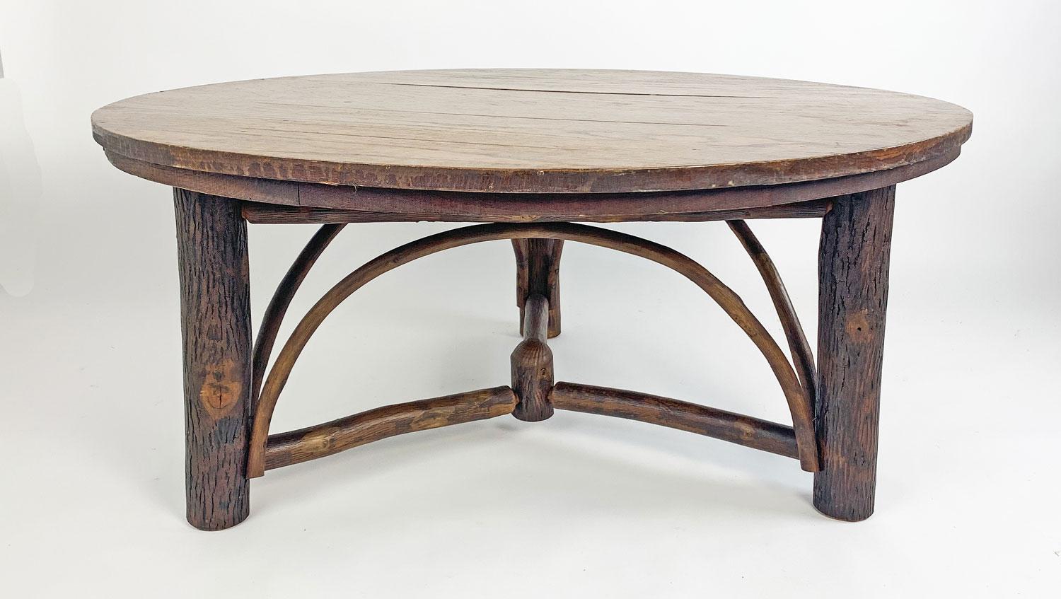 Old Hickory coffee table from the 1930s that is in great condition. It has a round oak top and a fabulous hickory pole base with spoke stretchers and arches. It is 42