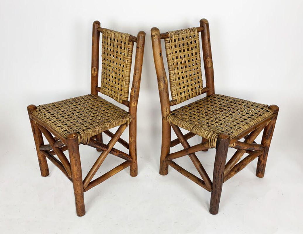 These are the sturdiest, most attractively designed dining chairs that Old Hickory made. Each chair retains its original open-weave rattan cane back and seat with a protective hickory half-round rail covering, and has “X” stretchers on three sides