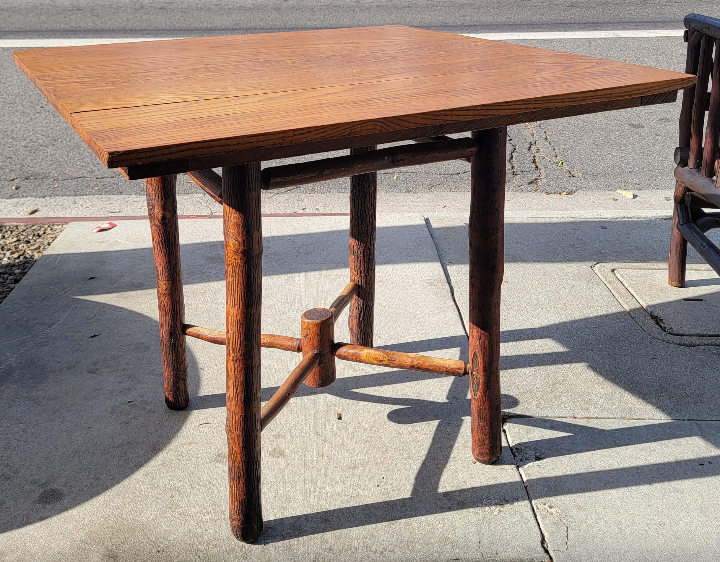 This fine oversize gaming table or small dinning table is in fine sturdy condition.This signed Old Hickory Martinsville,Indiana is stamped under the top of the table.Wonderful original aged patina.