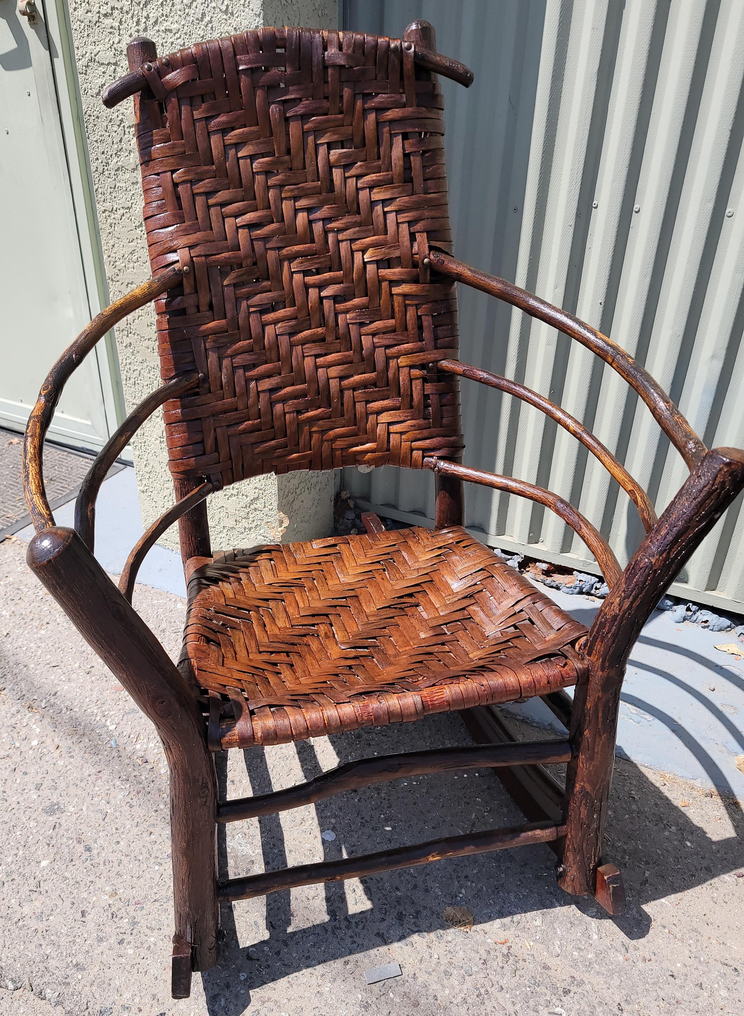 Beautiful 19thc  old hickory rustic  high back rocking chair. Great  sturdy condition.
This rocking chairs is a hand made and hand woven seat & backing.This was found in Pennsylvania.