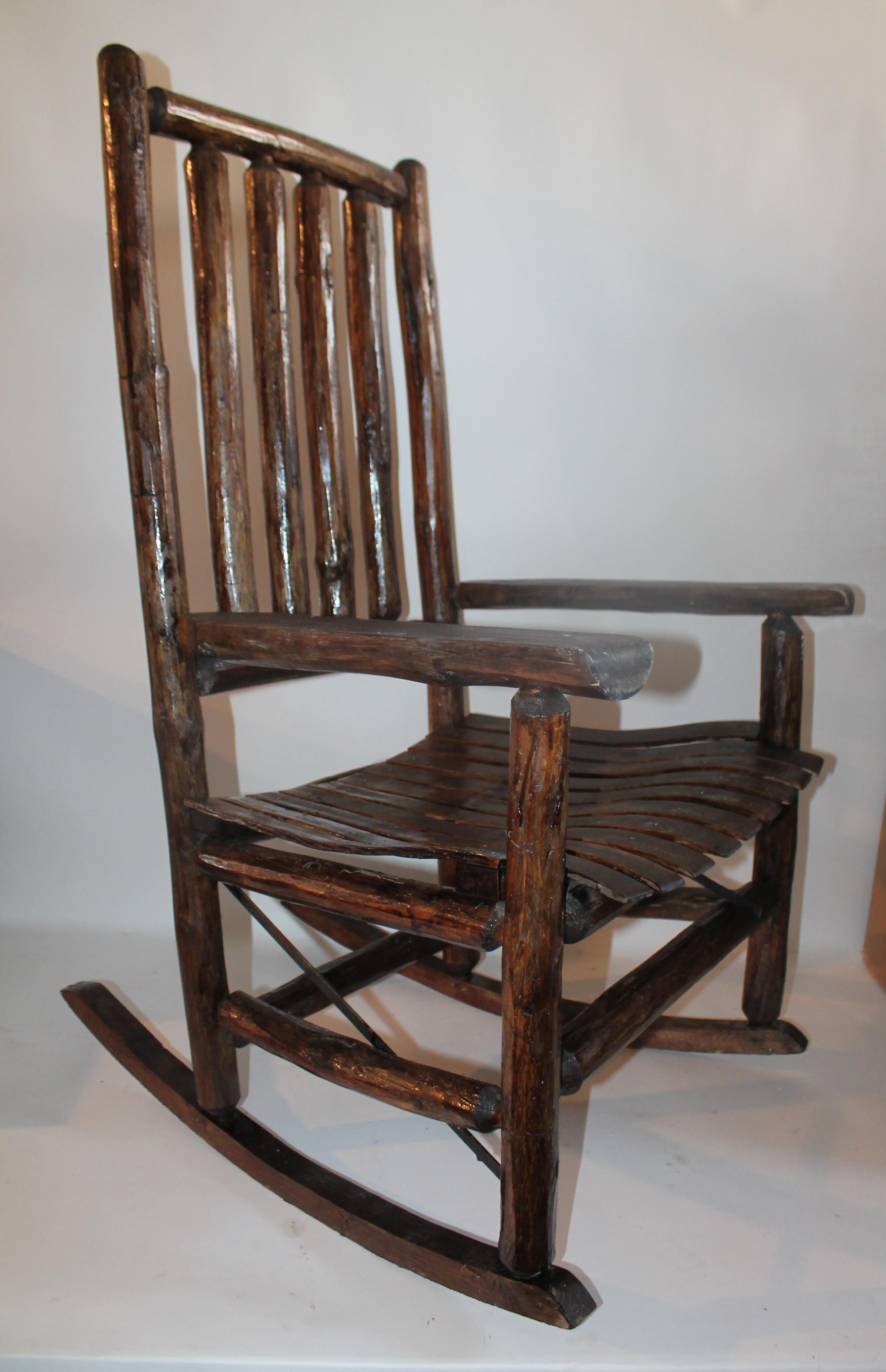 This Fine old hickory rocking chair came from a ranch house in Texas. The condition is very good and it has a coat of all-weather protector varnish.