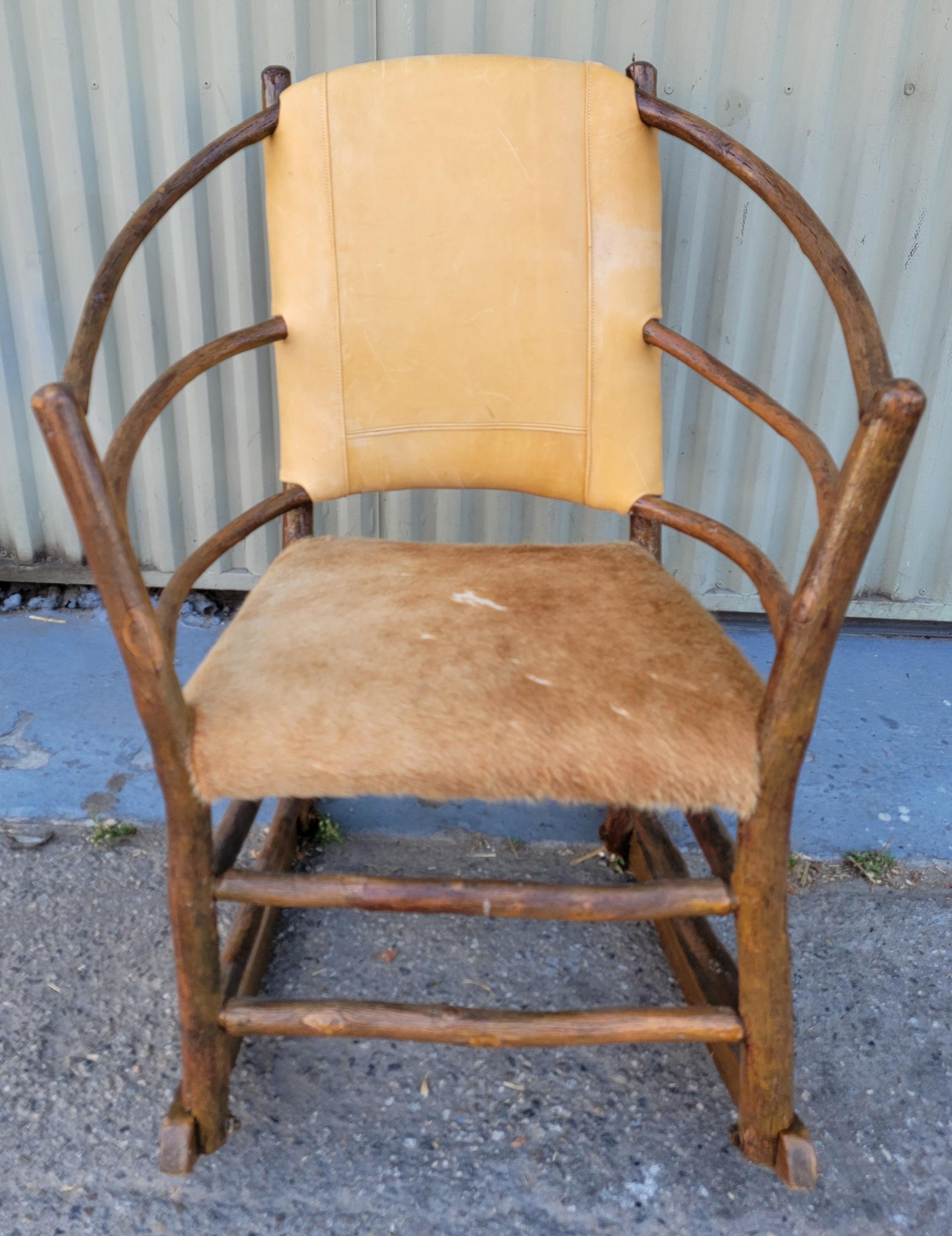 This folk Old Hickory Rocking chair is upholstered in pieced leather from a vintage old Ralph Lauren sofa.The seat is covered in deer skin.The condition and patina is fantastic.