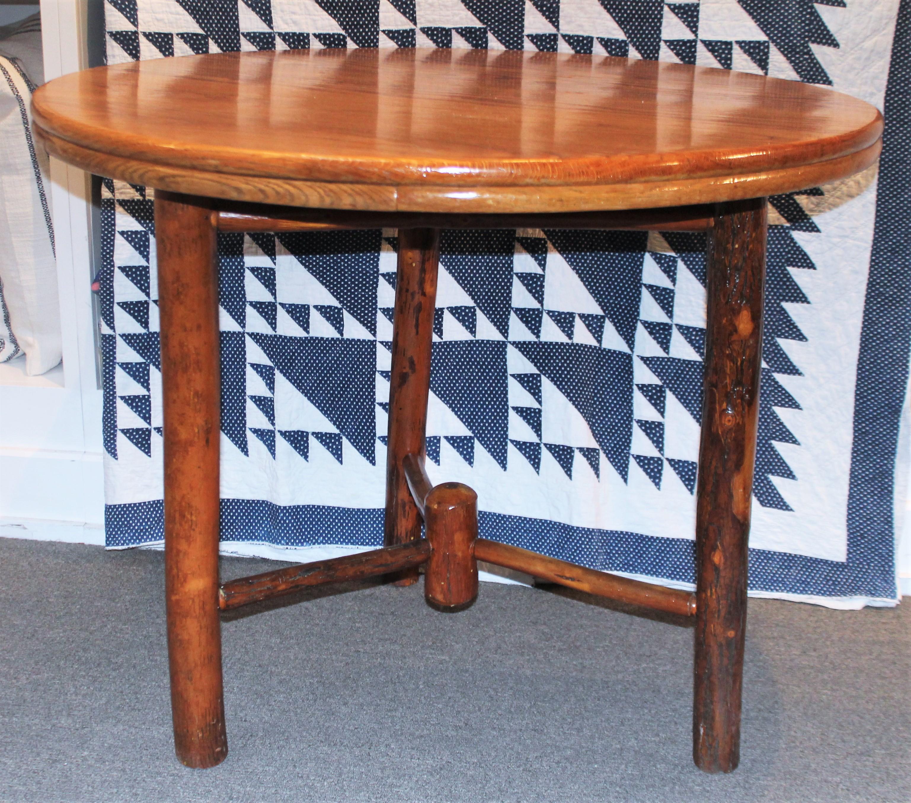 Early 20th century round hickory dining table. Old hickory manufacture. Has been sealed to protect wood from all weather. This item has been checked for strength and stability.