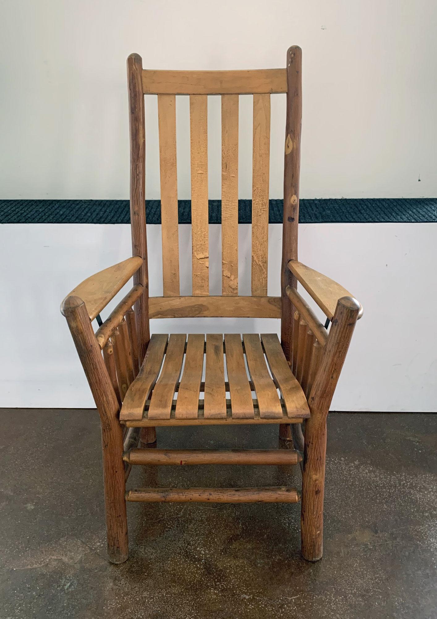 Old Hickory tall-back paddle-arm chair with slat seat and back, circa 1940. 
Stamped Old Hickory Furniture Co., Martinsville, this side chair is in pristine condition. 
Wonderful old hickory side chair with slat arms for comfort and that old country