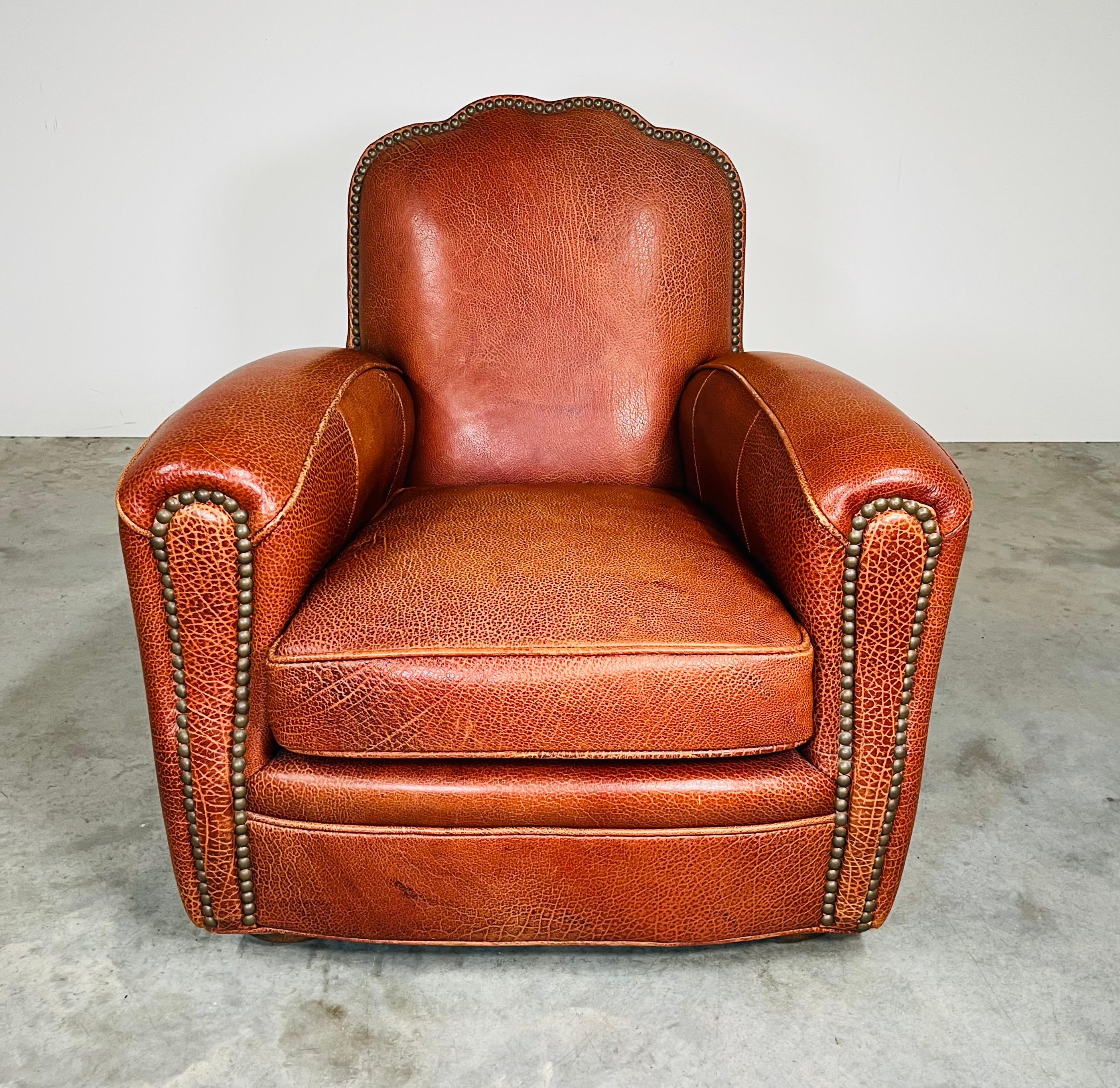 Experience handcrafted luxury in this American made armchair having plush down cushioning enveloped in genuine “Spirit Brown” leather decorated with nailhead trim  over subtle walnut ball feet. This timeless design compliments any traditional