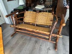 Old Hickory, two seat glider, rustic log frame with rettan