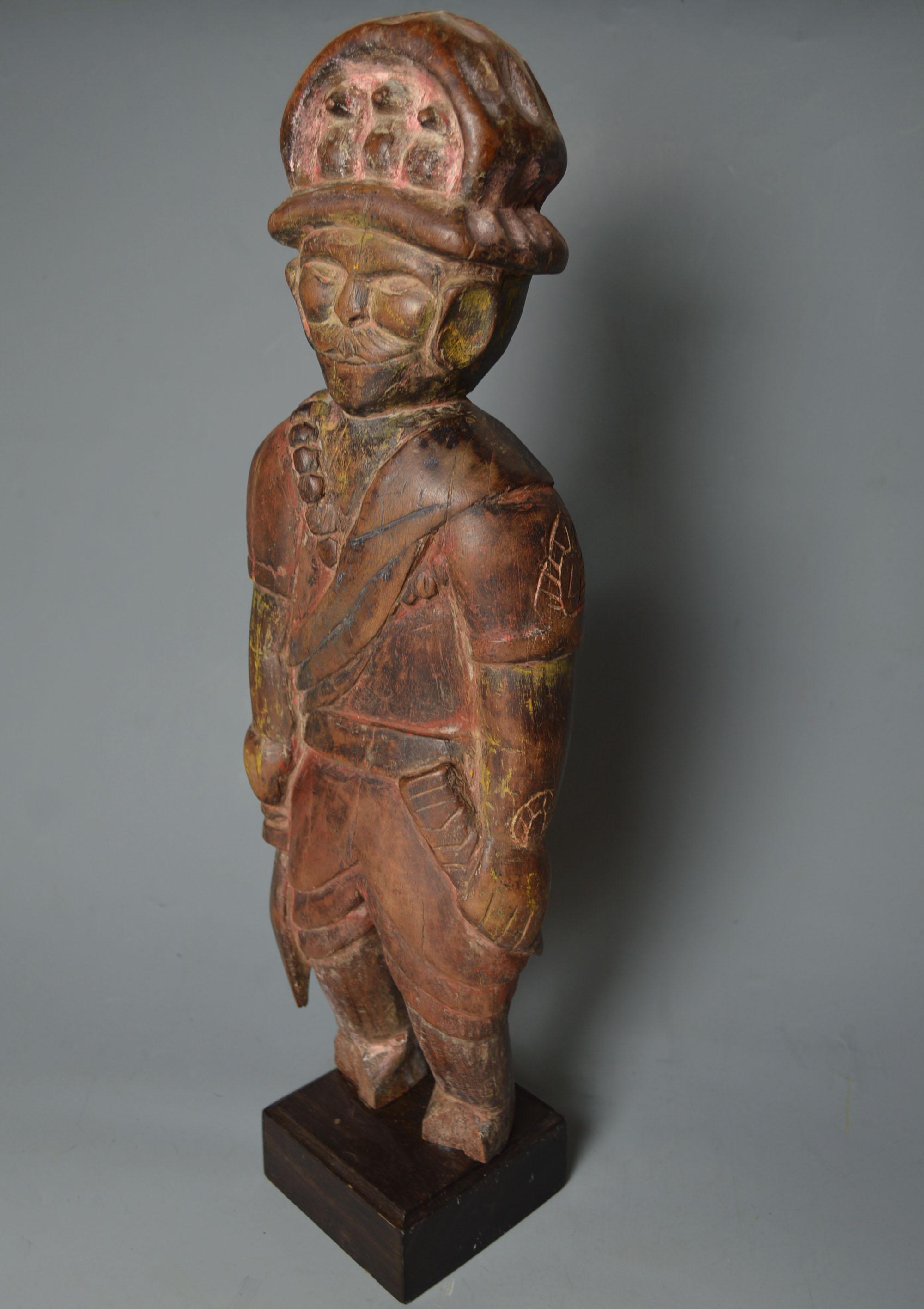 A rare and interesting old Himalayan / Tibetan folk art figure of a soldier or warrior.
The standing figure with large Avian embellished headdress with bandolier and holding a sword, the face finely and skilfully carved with distinct Himalayan