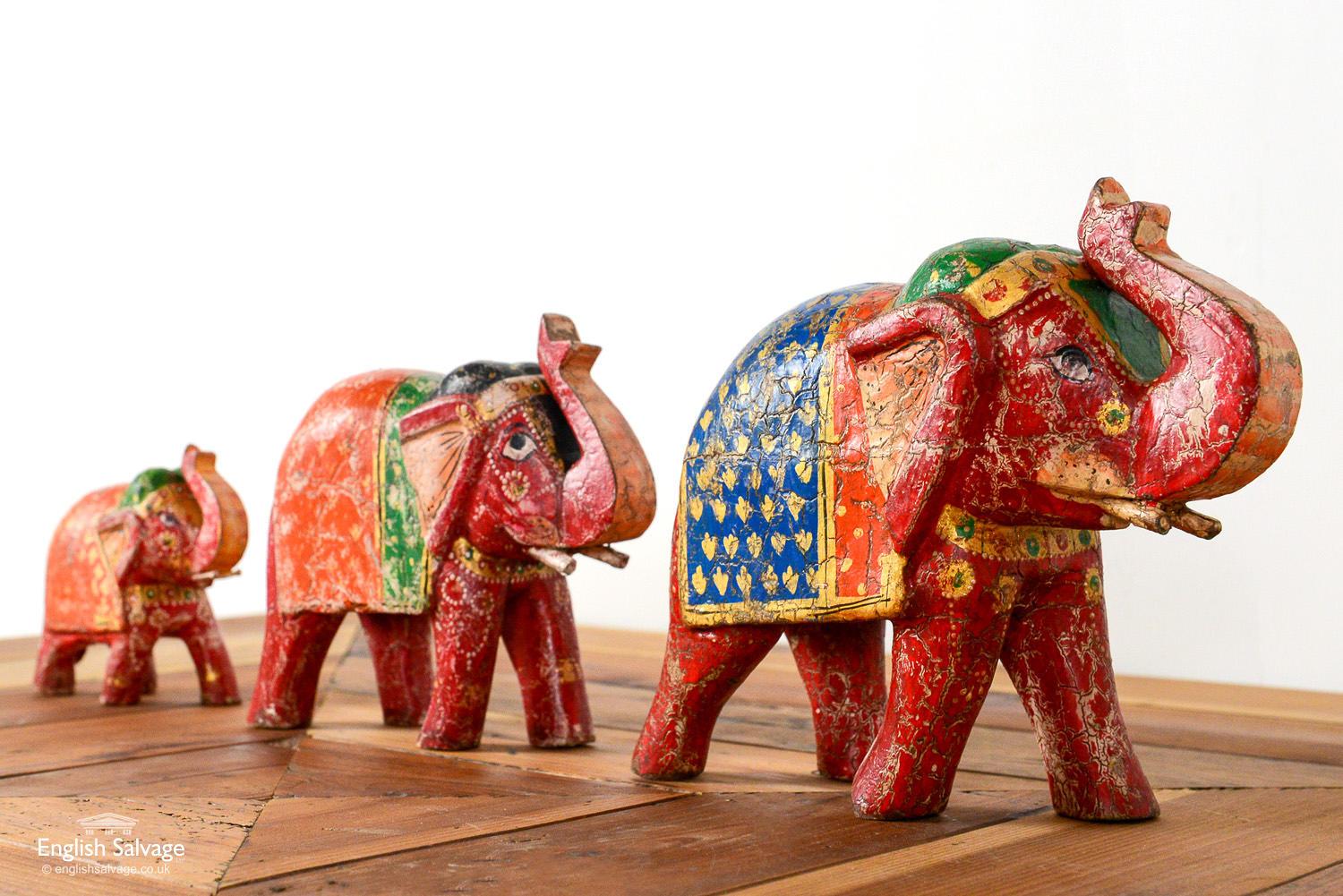 Old reclaimed hand painted wooden Indian elephants. Large elephants (x1) £100 measure: 10 cm x 19 cm x24 cm. Medium elephants (x2)  measure: 8 cm x 16 cm x 20 cm. Small elephants (x2)  measure: 5 cm x 11 cm x 13 cm. Chips and scuffs to the paintwork