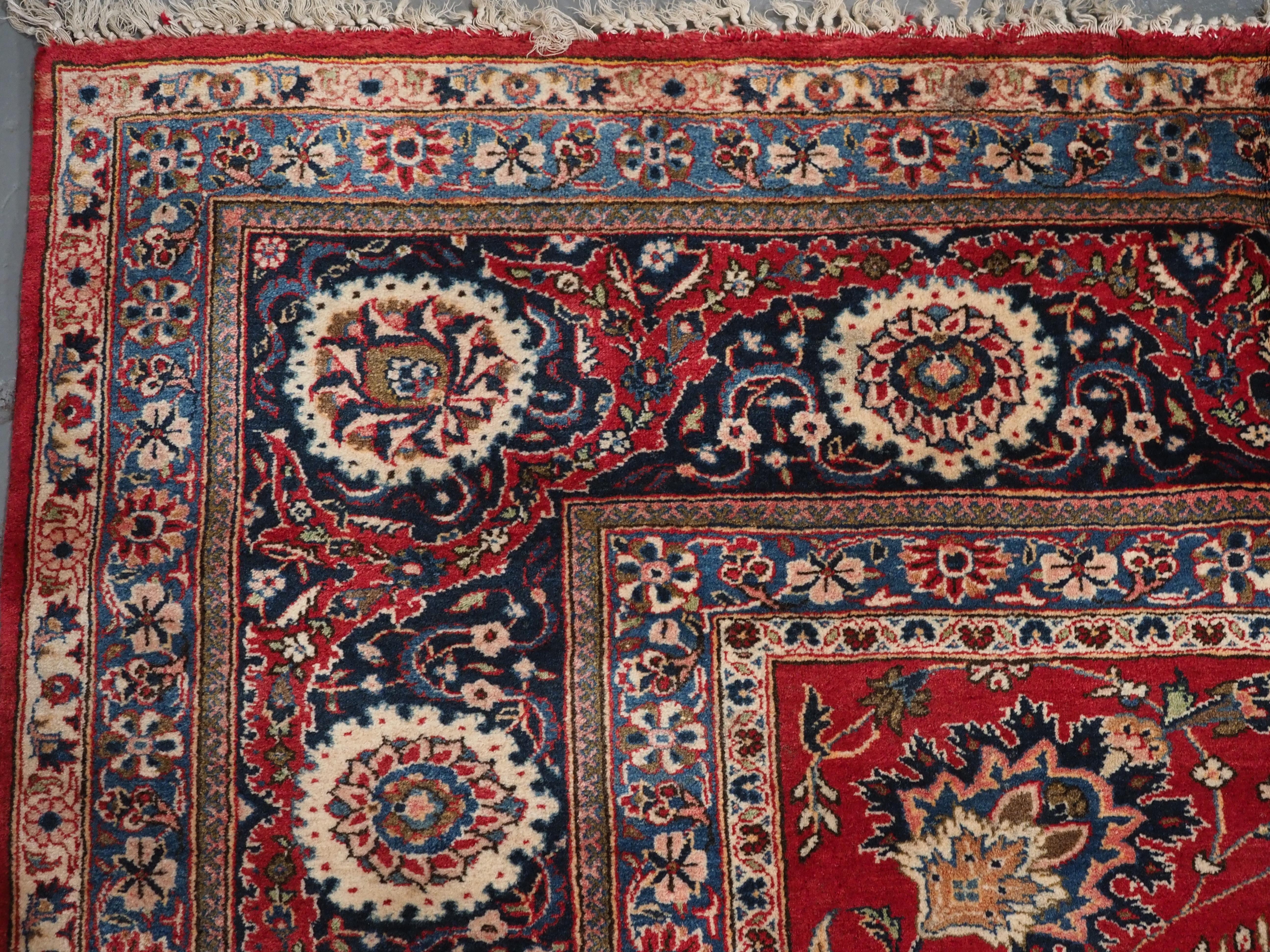 Size: 12ft 11in x 9ft 1in (393 x 278cm).

Old Kashan carpet of classic all over design and good colour, ideal for heavy duty furnishing use.

Circa 1930.

The carpet has a field of floral designs on a rich red ground.

The border is of a classic