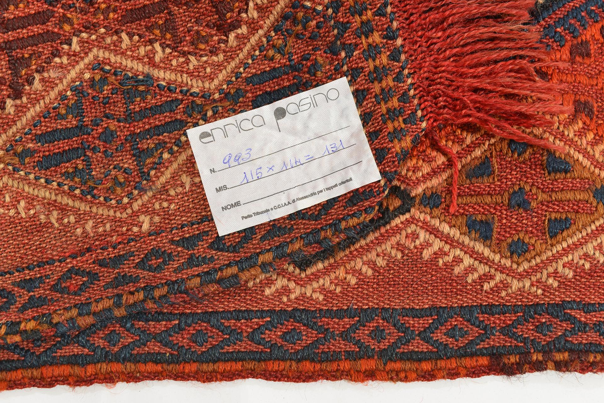 An old fully embroidered kilim-cicim: a simple nomadic product made up of two parts because it was woven without a fixed frame during the various movements of the tribe.
For this reason it is not perfectly square.  You can use it on a bench or also