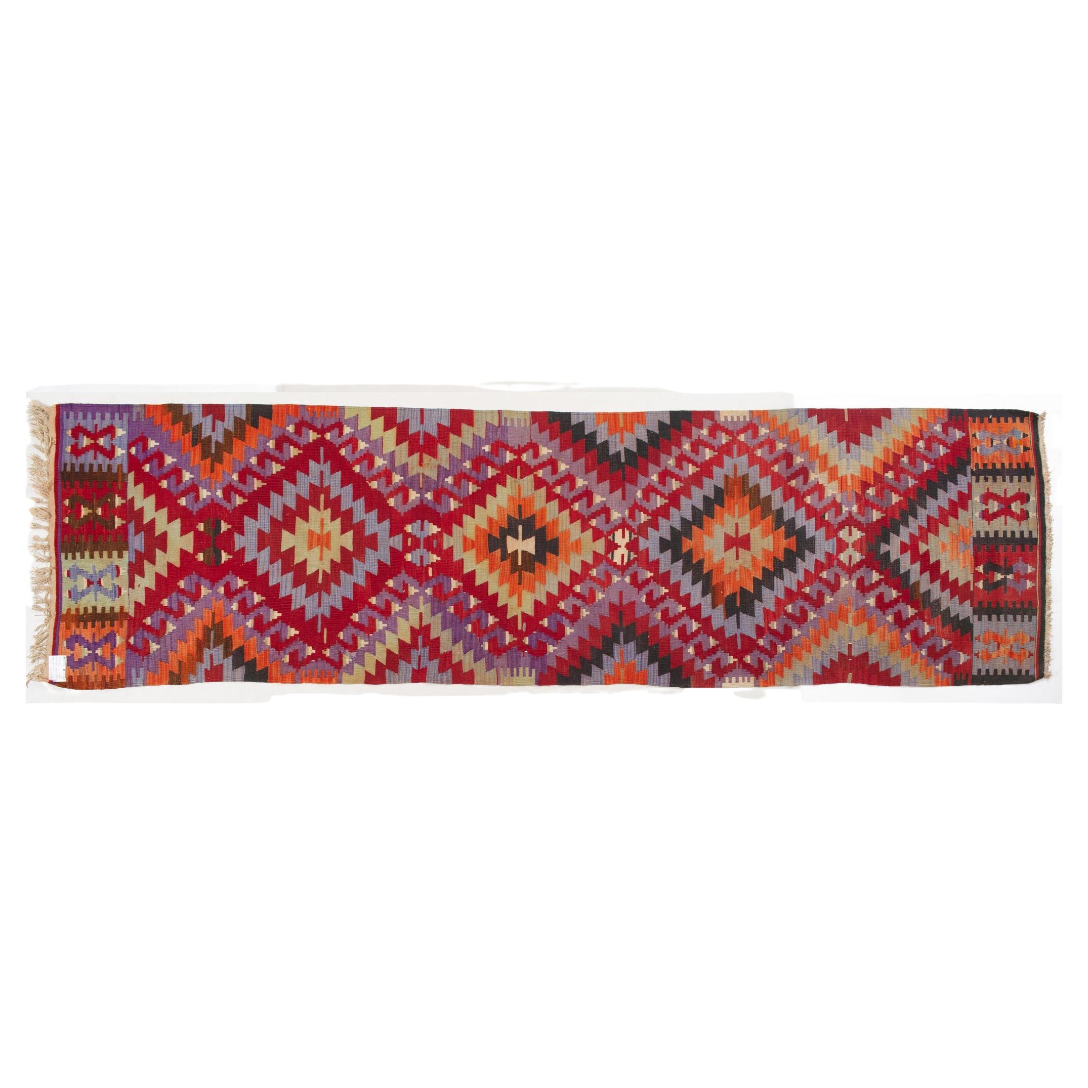 Typcal Turkish kilim, here in a runner version: cheerful pastel colors in a purely geometric pattern.
Right fit in front of the cupboard.
 