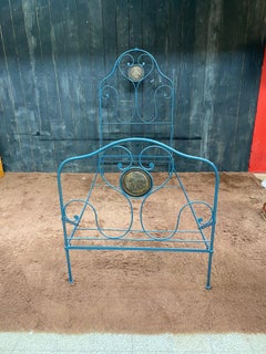 Old lacquered wrought iron bed, coming from a religious congregation circa 1900
