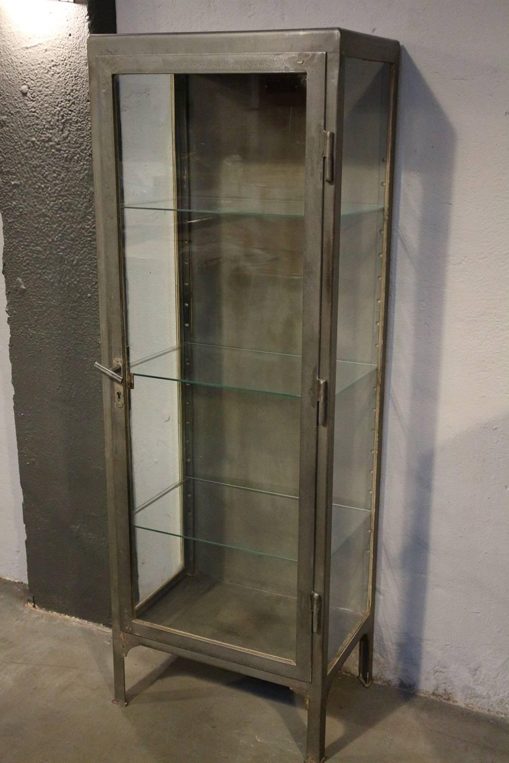 Old metal display cabinet. Originally this has been a medicine cabinet. Beautifully lived through. Three adjustable glass plates.
Origin: Poland, Warsaw
Period: circa 1950
Measure: W 59cm, D 40cm, H 170cm.