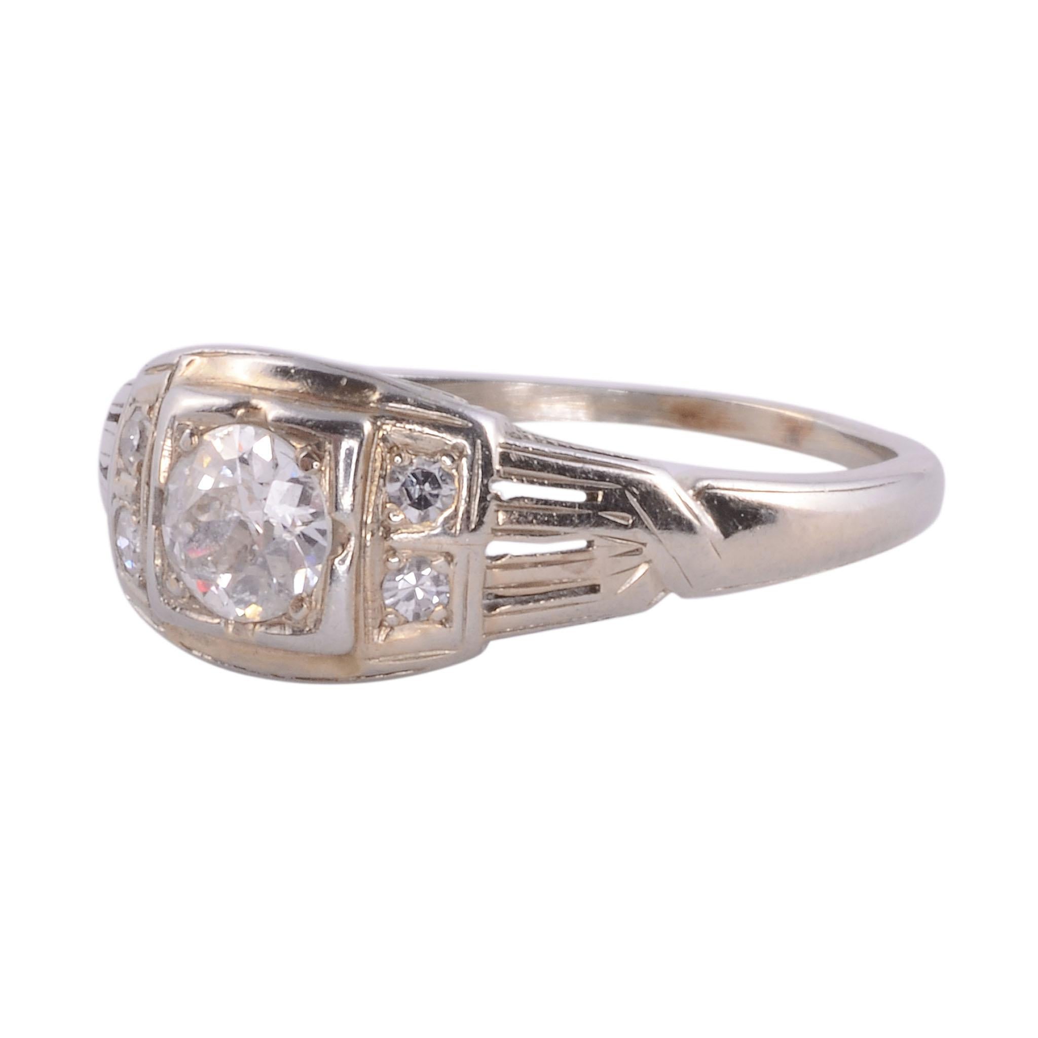 Vintage old mine cut diamond 18KW ring, circa 1930. This 18 karat white gold ring features an Old Mine cut diamond center at .36 carat, I1 H. It is accented with four side diamonds at approximately .12 carat total weight, VS G-H. This ring is a size