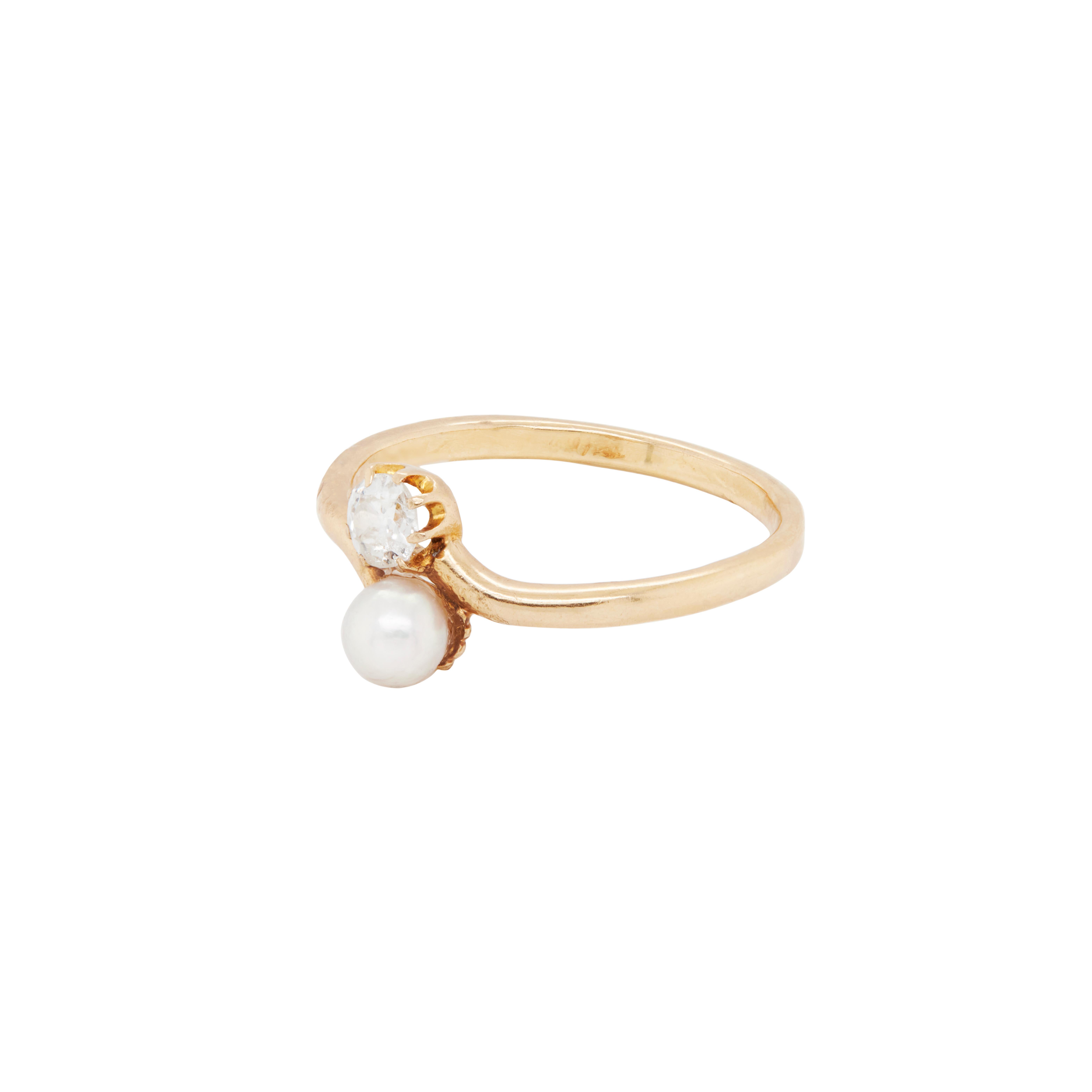 This beautiful Edwardian pearl and diamond ring couldn't be more romantic in style.

Set in a simple toi et moi design is a wonderful and lively old mine cut diamond that has been beautifully paired with a white to pale grey pearl to complement the