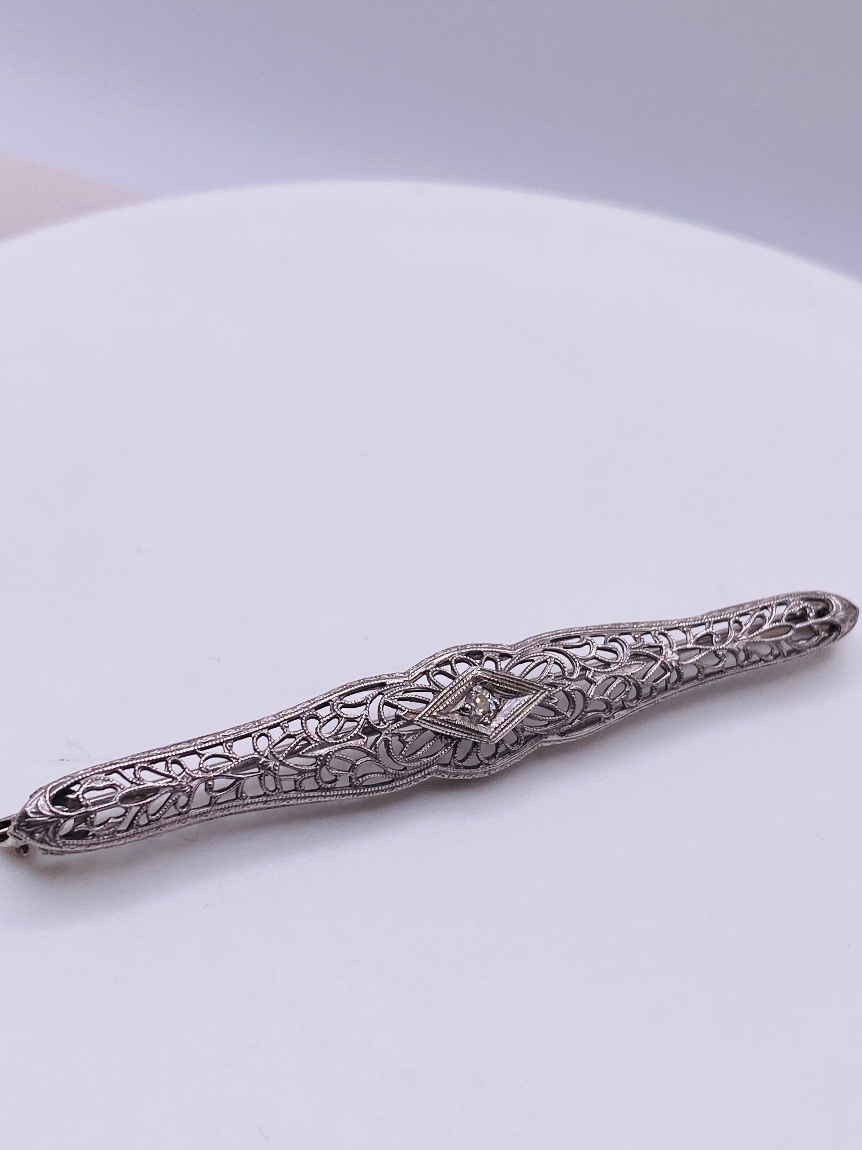 18k white gold antique reproduction filigree brooch pin with 2.50 x 2.40 mm, .06 carat old mine cut J/K Si2 diamond. 3.0Dwt. 65mm long.