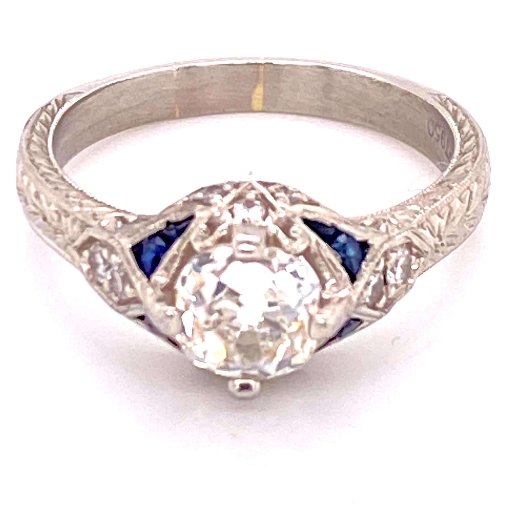 Fabulous Old Mine Cut diamond Deco style engagement ring fashioned in platinum. The ring features a center Old Mine cut diamond weighing 1.20 carats and another 10 Old European cut diamonds weighing .20 carat total weight. The mounting also features